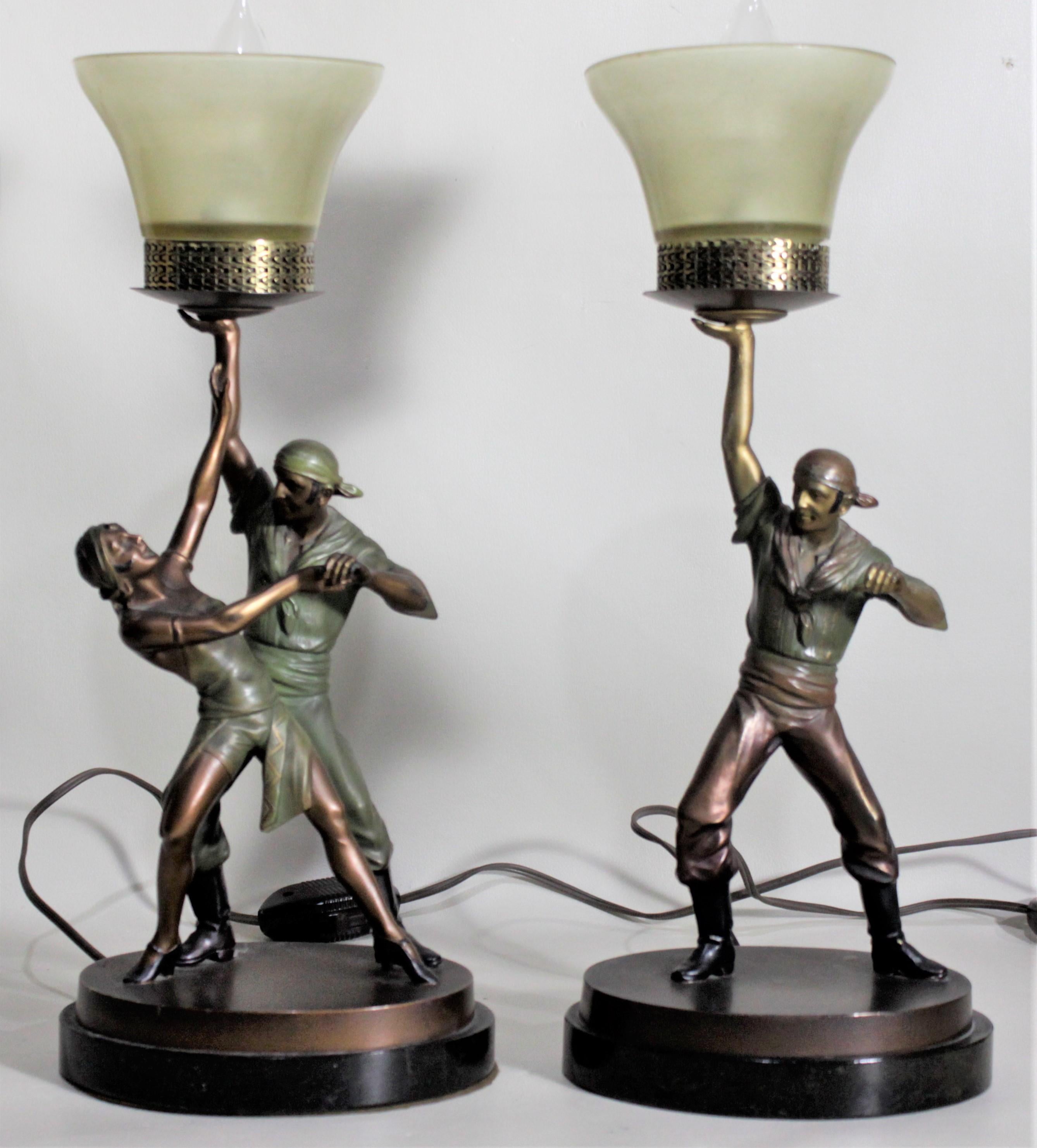 This pair of cast spelter lamps are unsigned but believed to have been made in Austria in circa 1920 in the period Art Deco style. Each lamp is ornately cast and cold-painted and depict figural theatrical pirate figures in a bronze toned finish with