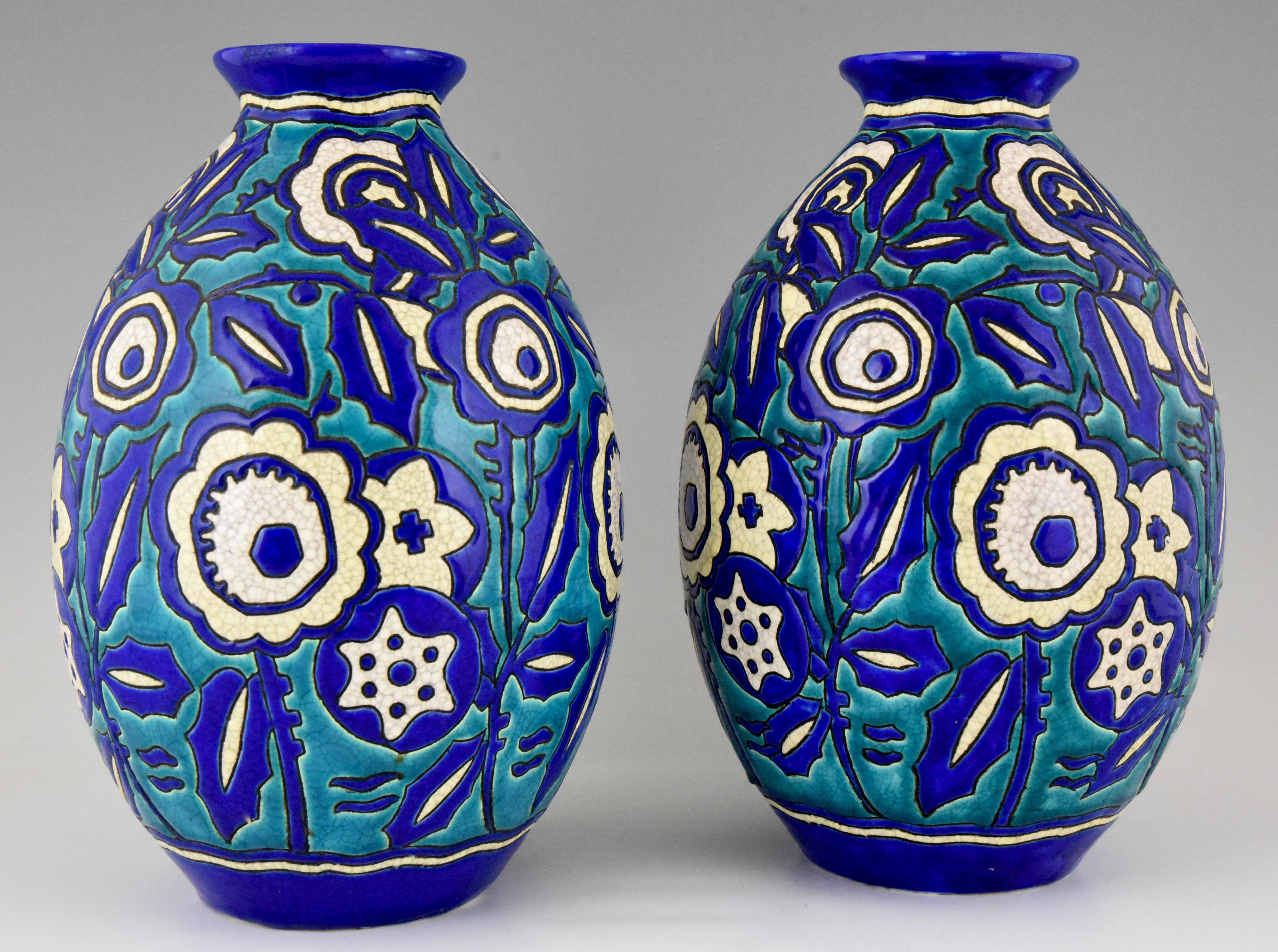 Beautiful pair of large Art Deco vases in craquelé ceramic design by Charles Catteau for Keramis, Belgium. Great shape and lovely color combination of blue, turquise, pale yellow and white. Signed by the artist and numbered. 
Belgium 1929.
This