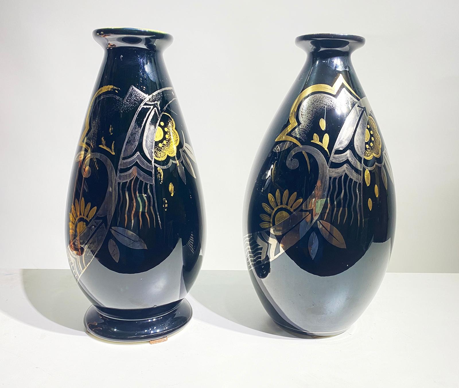 False pair of ceramic vases with Art Deco pattern in silver and gold on a black shiny glaze by Boch Frères, La Louvière Belgium, 1931-1932.
Dimensions of Vase 1 : Height 33 cm x Diameter 17 cm
Dimensions of Vase 2 : Height 33 cm x Diameter 19 cm.
