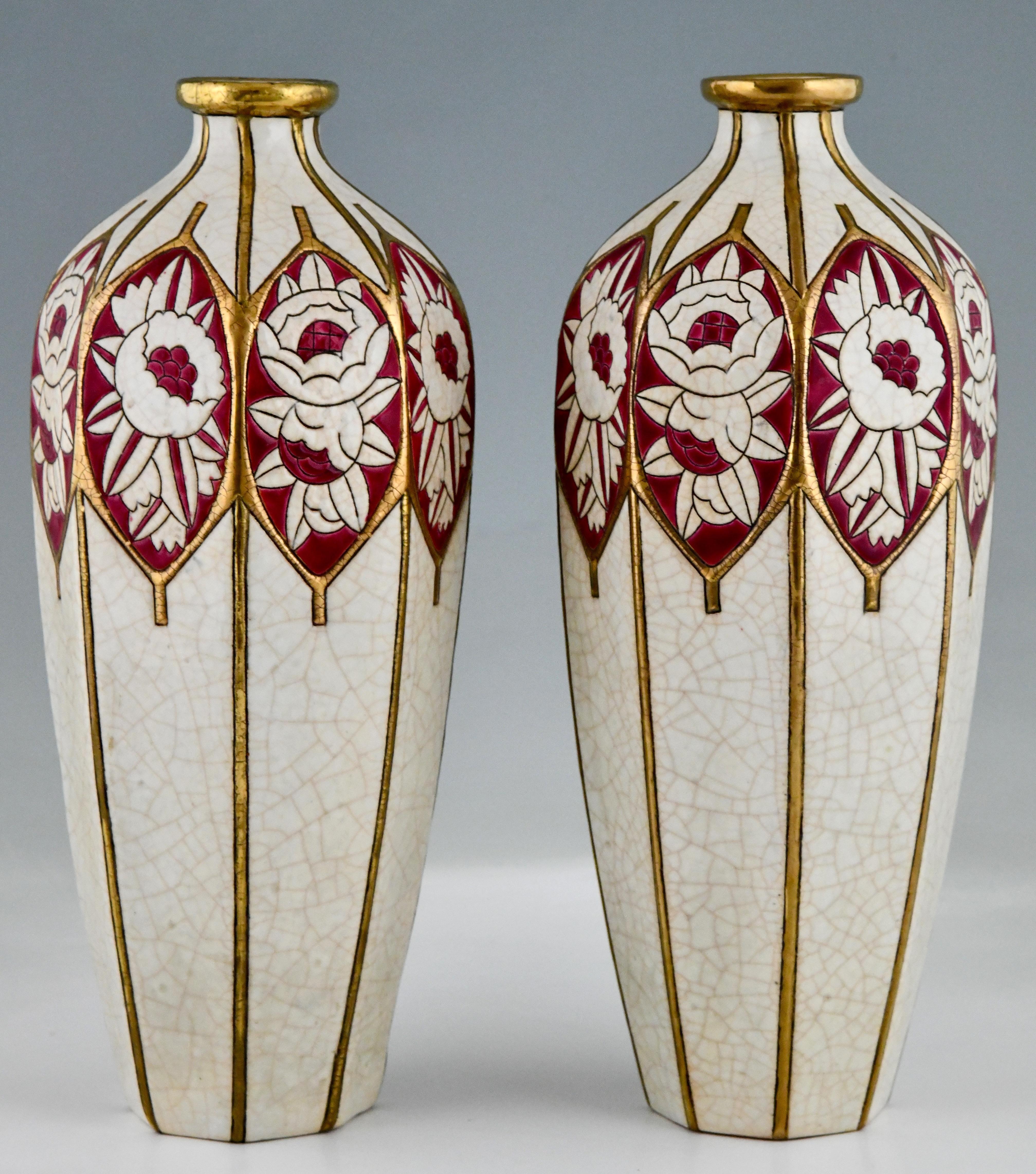 Pair of Art Deco ceramic vases with stylized peonies and rozes by Maurice Paul Chevallier for Longwy.
Glazed ceramic, craquelé, ivory, gold and purple. Shape: 3070. 
France 1925.

This model is illustrated in:
Catalogue Extraordinaire of 2003,