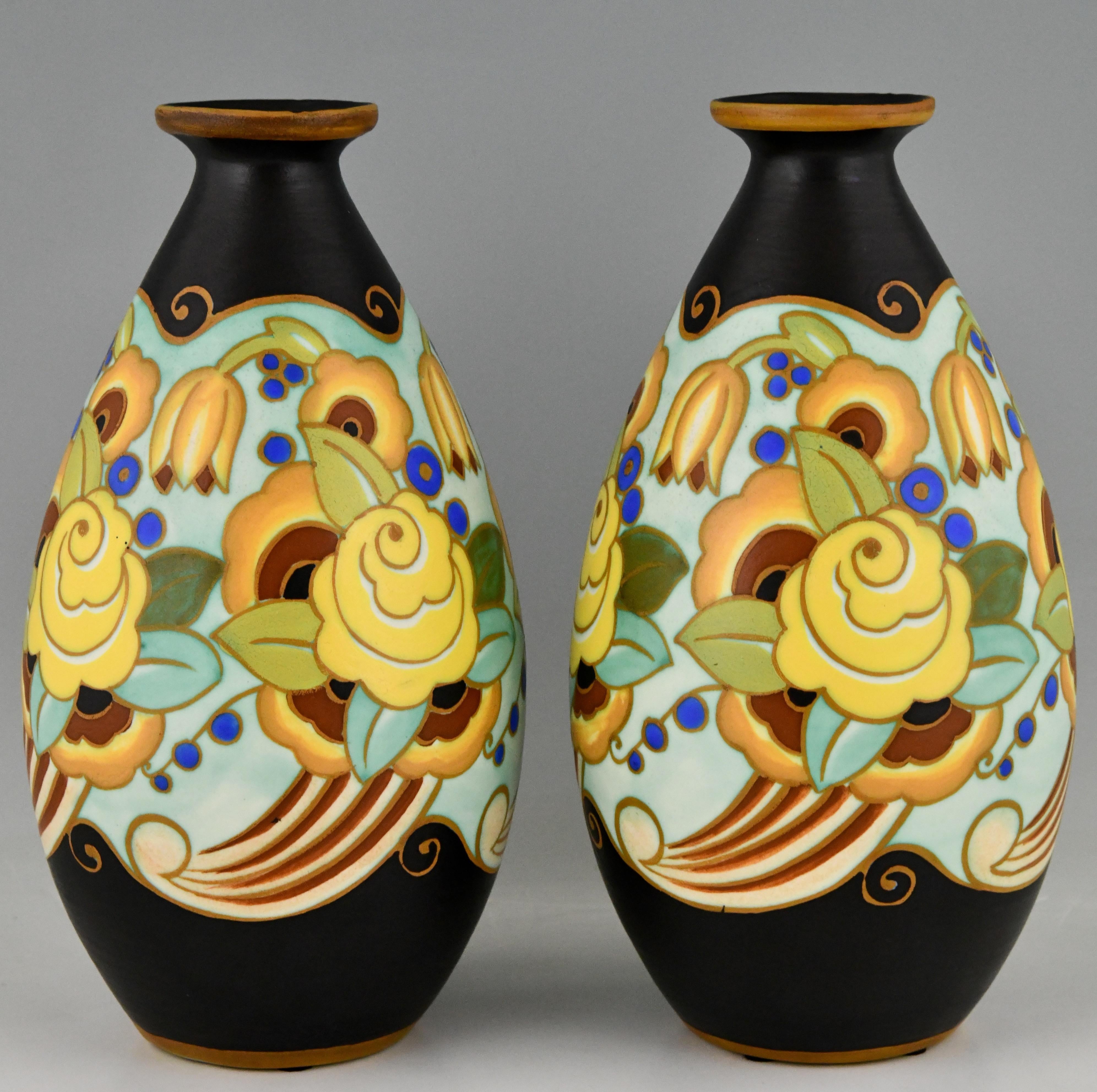 A pair of Art Deco ceramic vases with flowers by Boch Frères Keramis. Yellow flowers on a brown background. Belgium 1931/1932. Keramis stamp. Numbered D1733 for the decor.

This decor is illustrated in Art Deco Ceramics, Charles Catteau by Marc