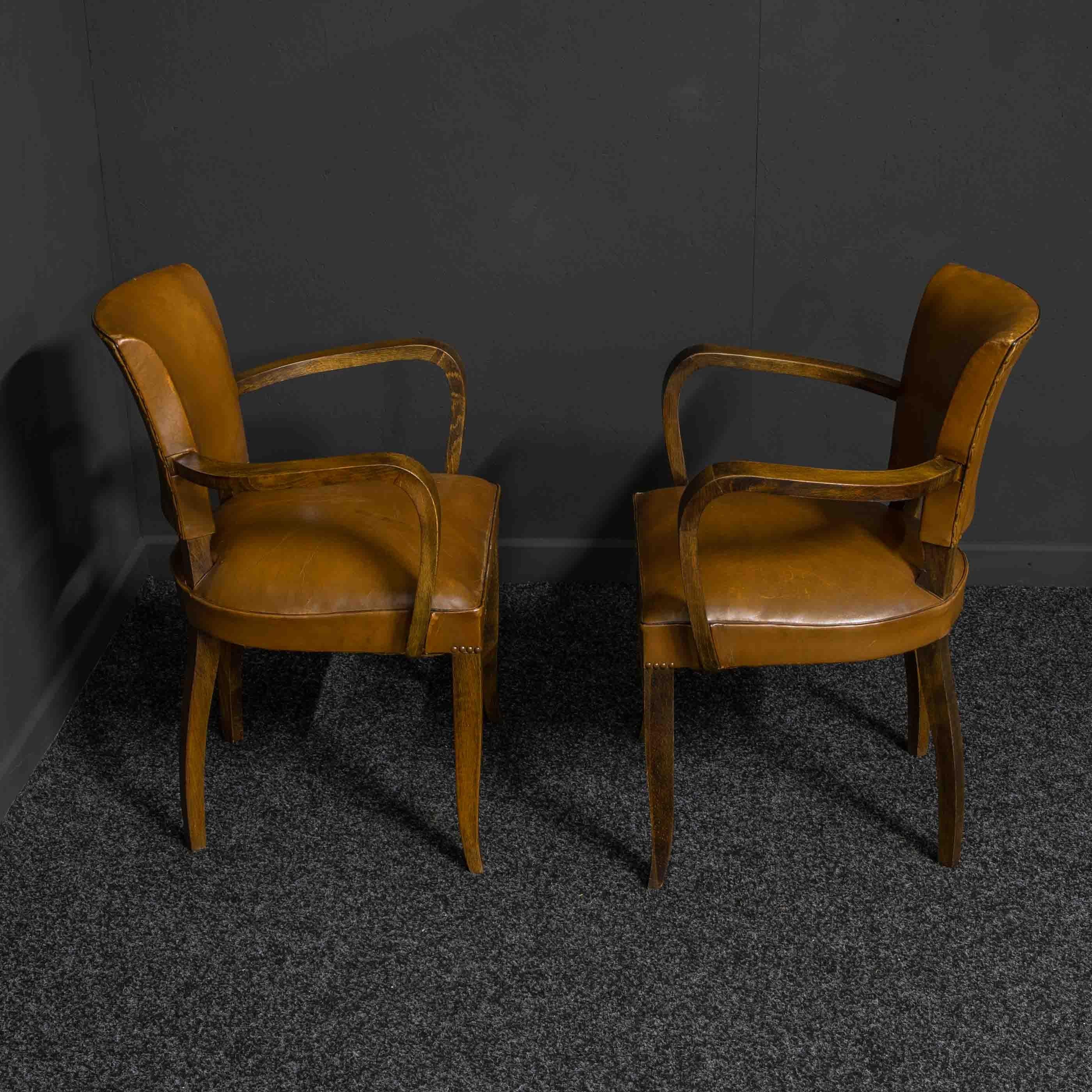 A lovely pair of French Art Deco armchairs by 'OXEDOU'. These chairs have slightly splayed legs and are still with their original leather upholstery. They are sturdy and in excellent condition.