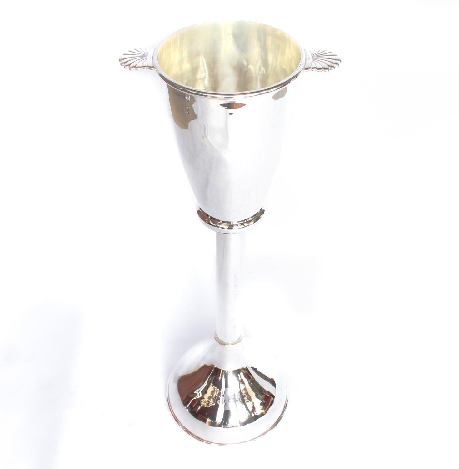 A pair of silver plated champagne buckets with banded detail and shell-shaped handles set on silver plated, weighted stands. Re-plated.






 