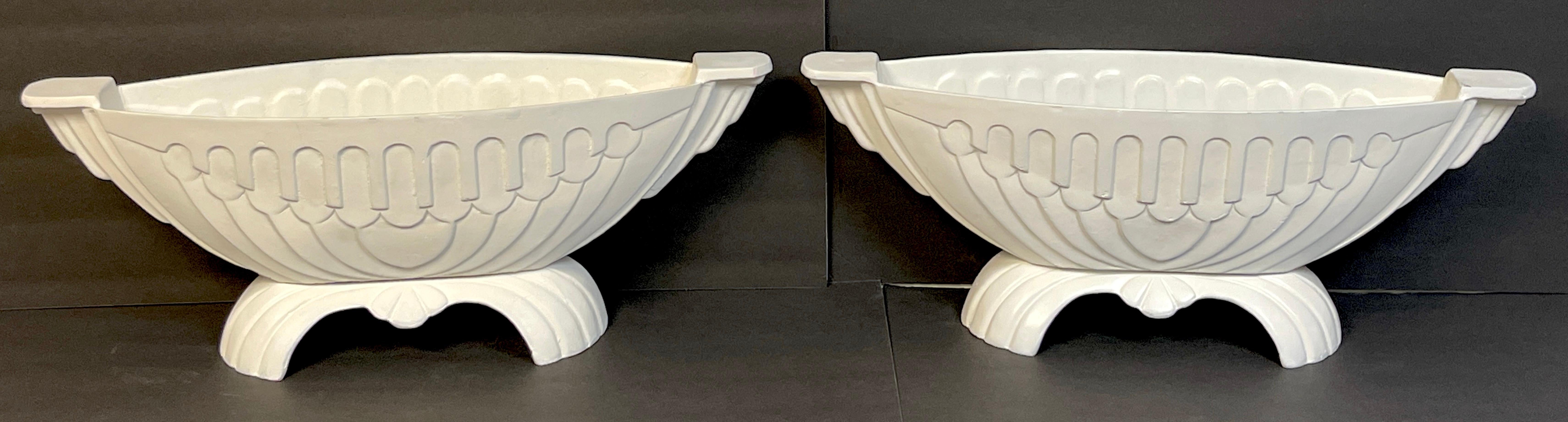 Pair of Art Deco channeled & arch design oval garden urns 
USA, Circa 1930s

Each one of cast aluminum with continuous arch and channel design, raised on 12