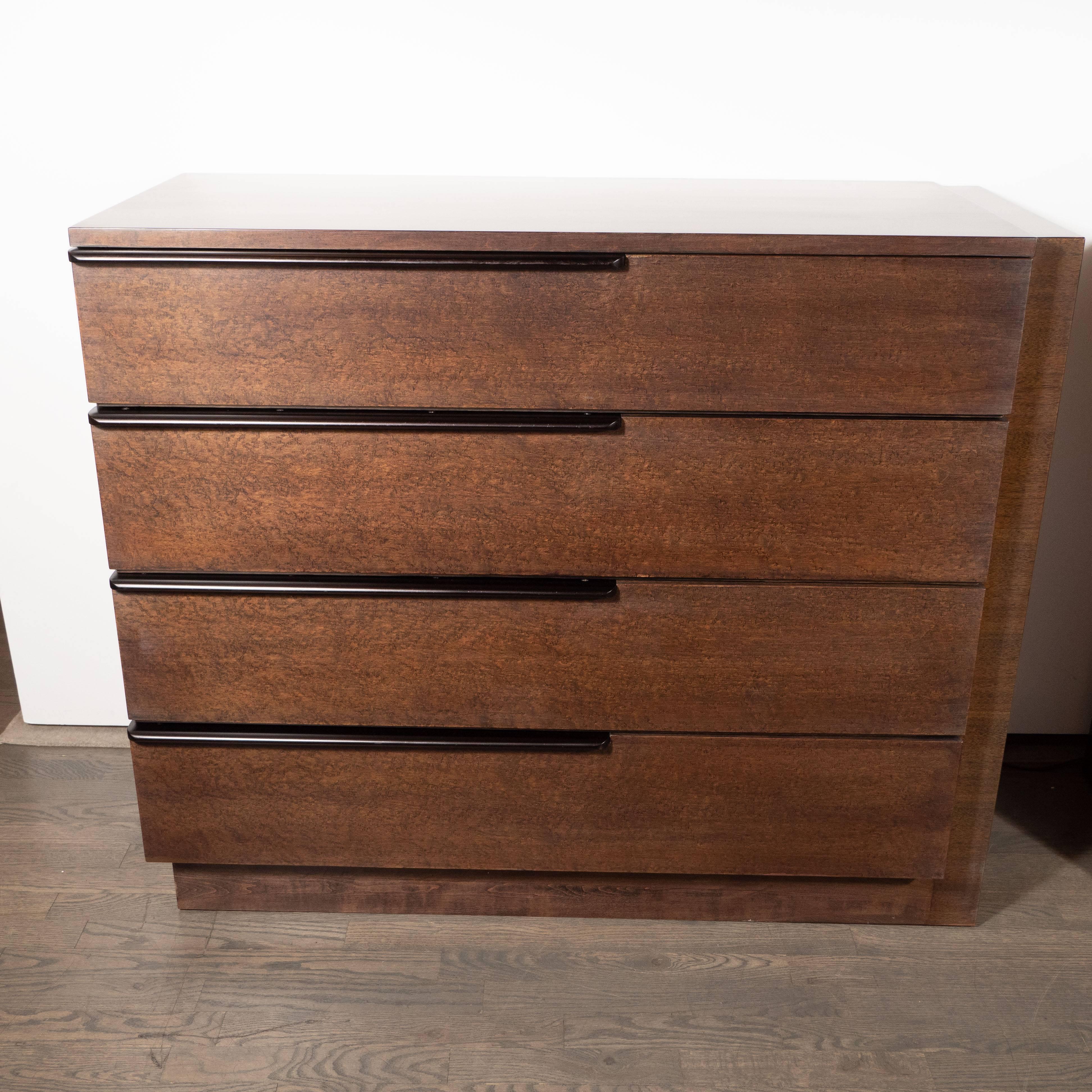 This stunning and elegant pair of Art Deco Machine Age chests were realized in the United States by the celebrated Mid-Century Modern Designer Gilbert Rohde for Herman Miller, circa 1940. They feature rectangular bodies in bookmatched and burled