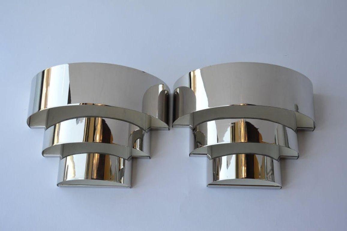 Pair of Art Deco chrome sconces.
Two candelabra light bulbs per sconce.