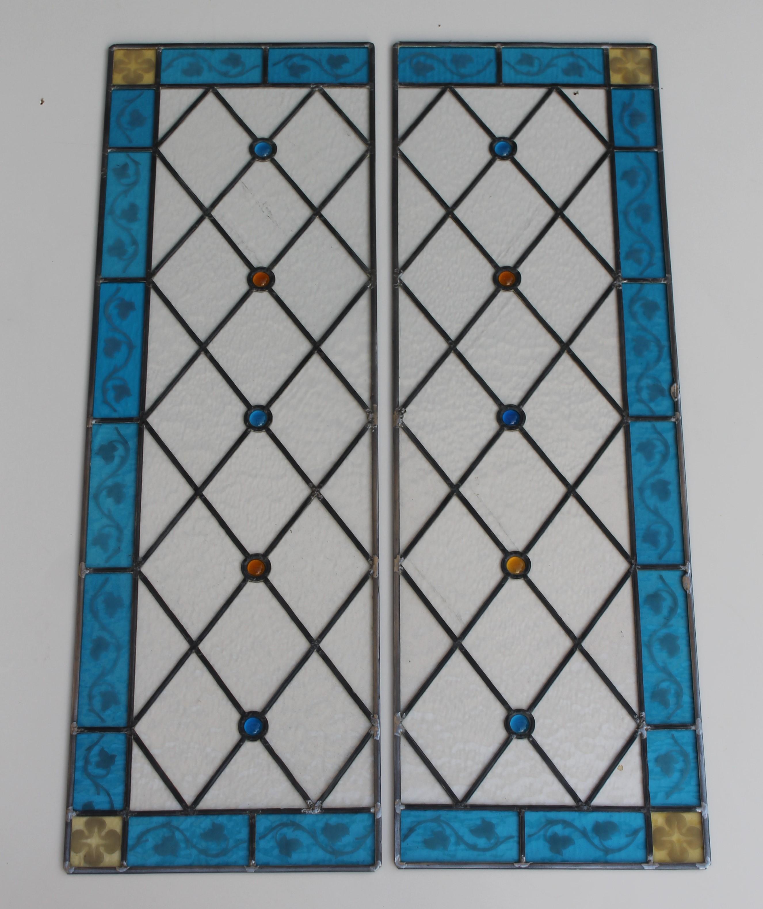 Two decorated stained glass panels, completely restored, dated, circa 1925.


