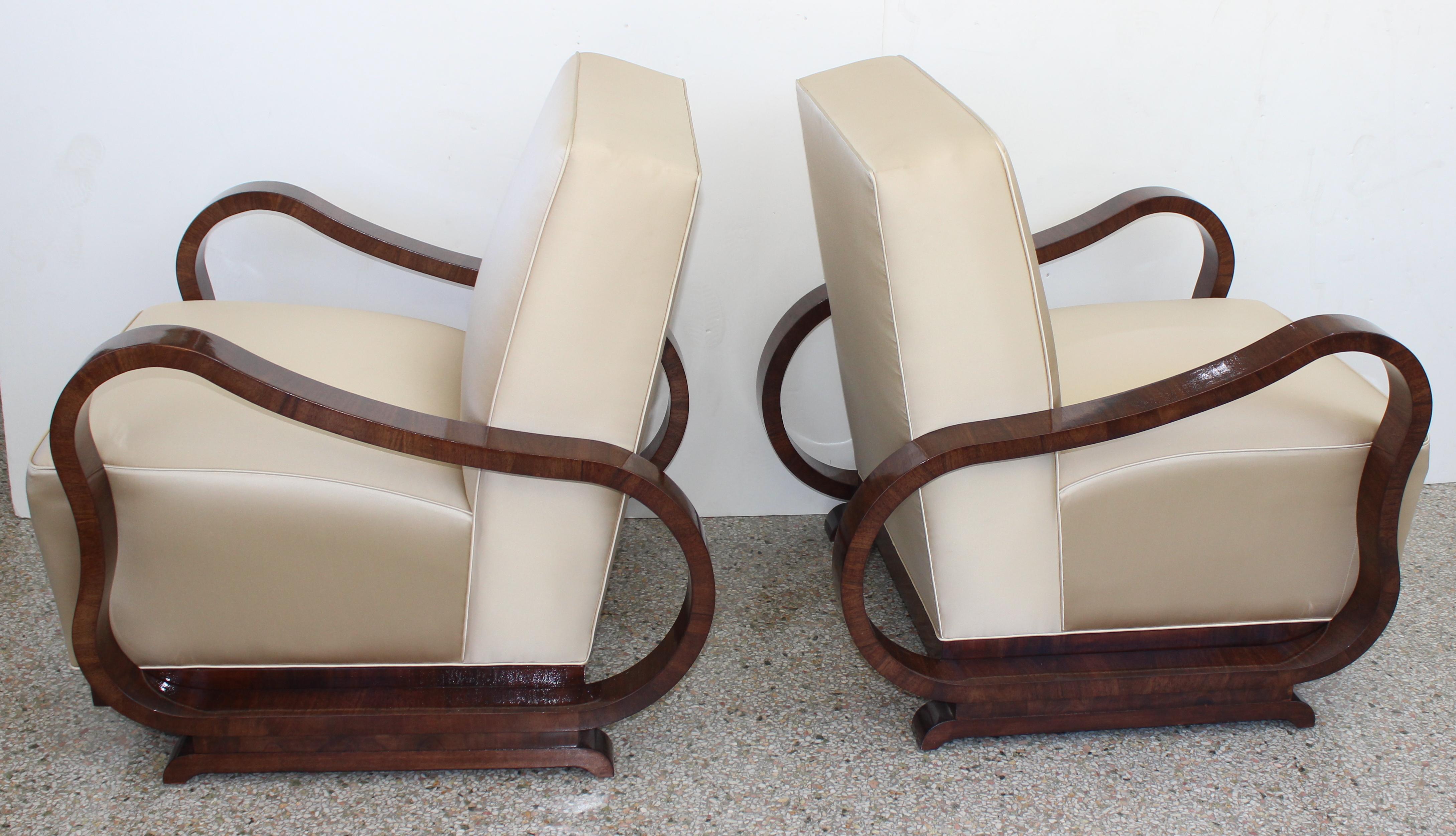 This stylish set of Art Deco style lounge chairs are attributed to the Czech designer Jindřich Halabala and they date to the 1930s. The frames are a deep walnut coloration, and the upholstery is a soft gold satin.

Note: We're not certain if the