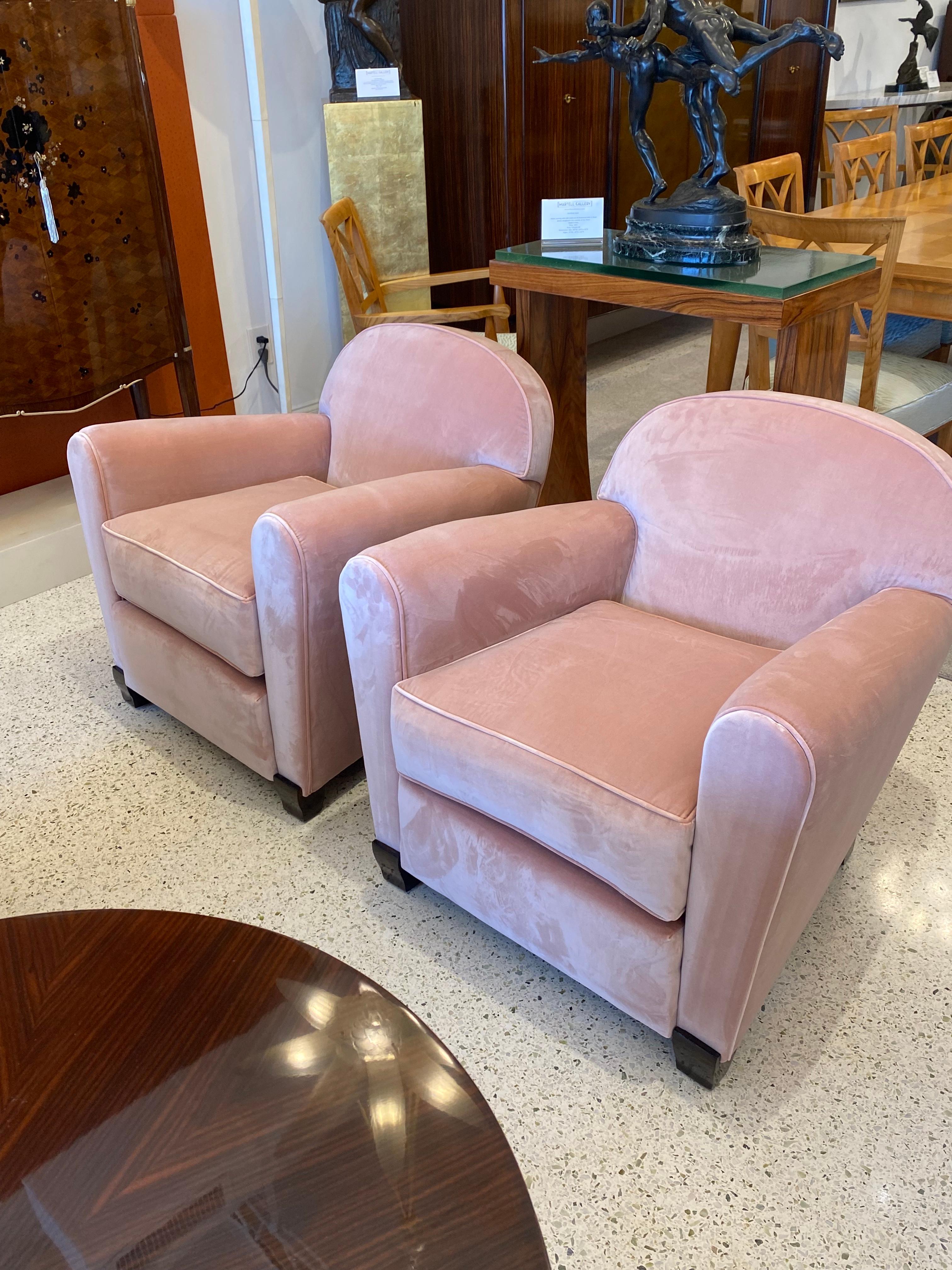 Pair of Club Chairs made out of a frame of solid Mahogany wood and upholstered in a Rosé color silk velvet.  These chairs were designed in France by Jules Leleu.
Reference: House of Leleu by Francoise Siriex, Page 73.

Jules Leleu was a prominent