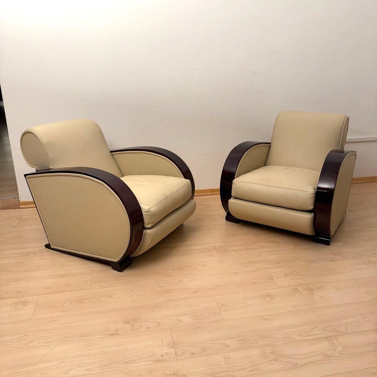 Pair of original Art Deco Club Chairs from France around 1930.
Reddish mahogany stained beech wood, lacquered and high gloss polished. Newly upholstered and covered with cream-colored genuine leather and double keder. Removable seat