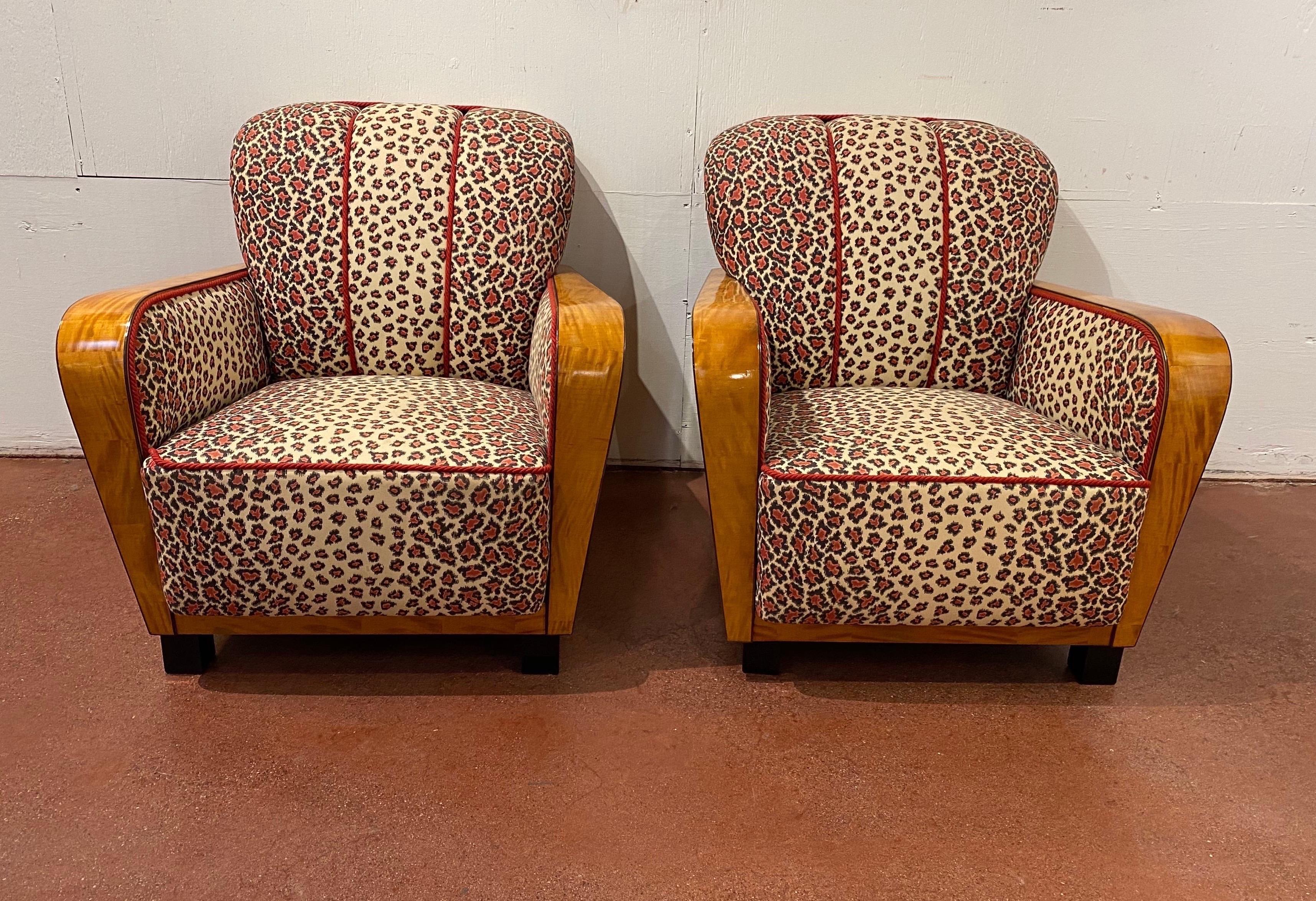 Incredible pair of Art Deco club chairs in satinwood and vintage leopard print upholstery. Wonderful quality satinwood veneer with ebony inlay. Chairs are in great shape and are stunning in person.