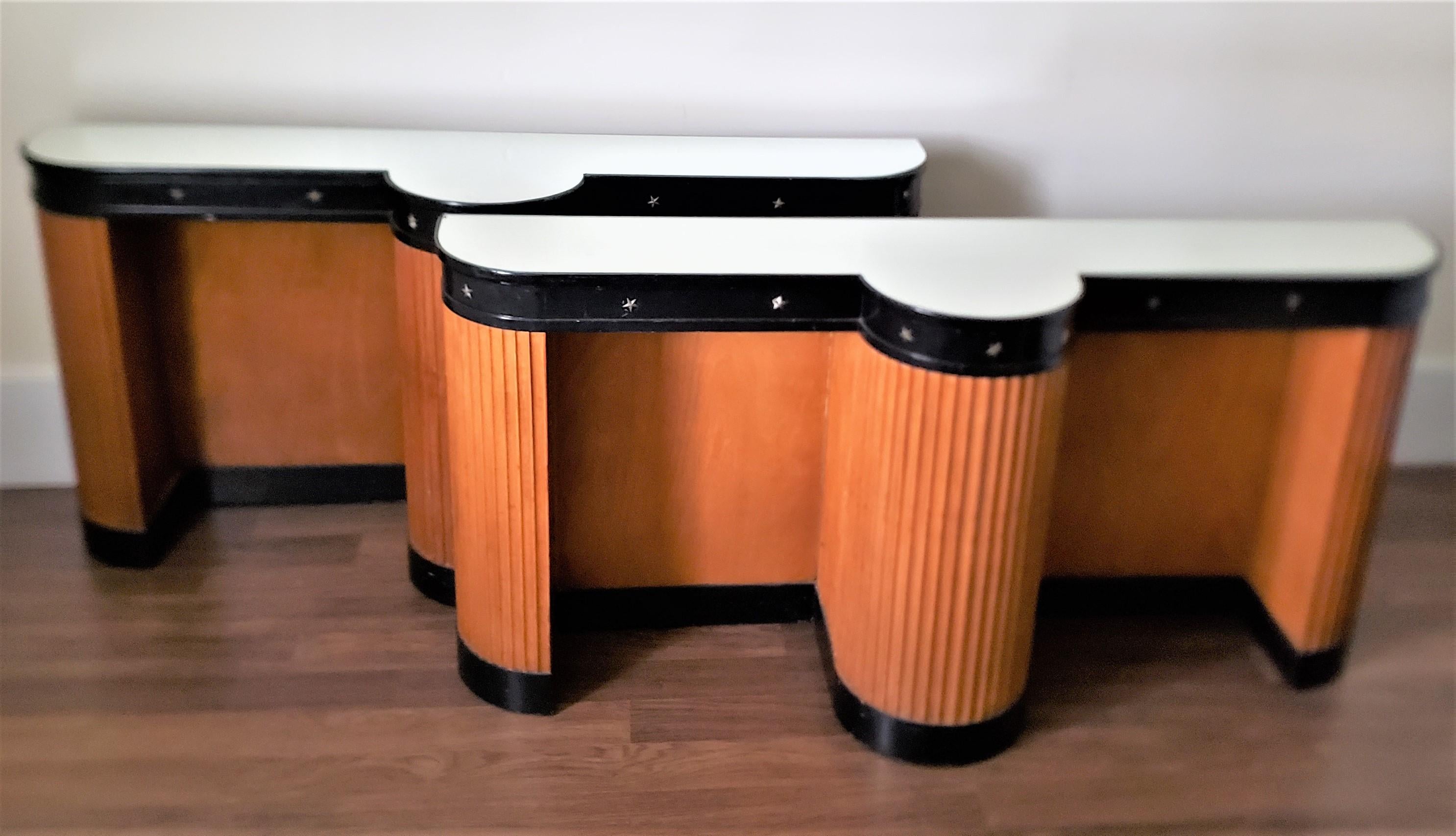 This pair of console tables or stands are unsigned, but presumed to have originated from the United States and date to approximately 1920 and done in the period Art Deco style. The consoles are composed of plywood and pine, with maple columns across