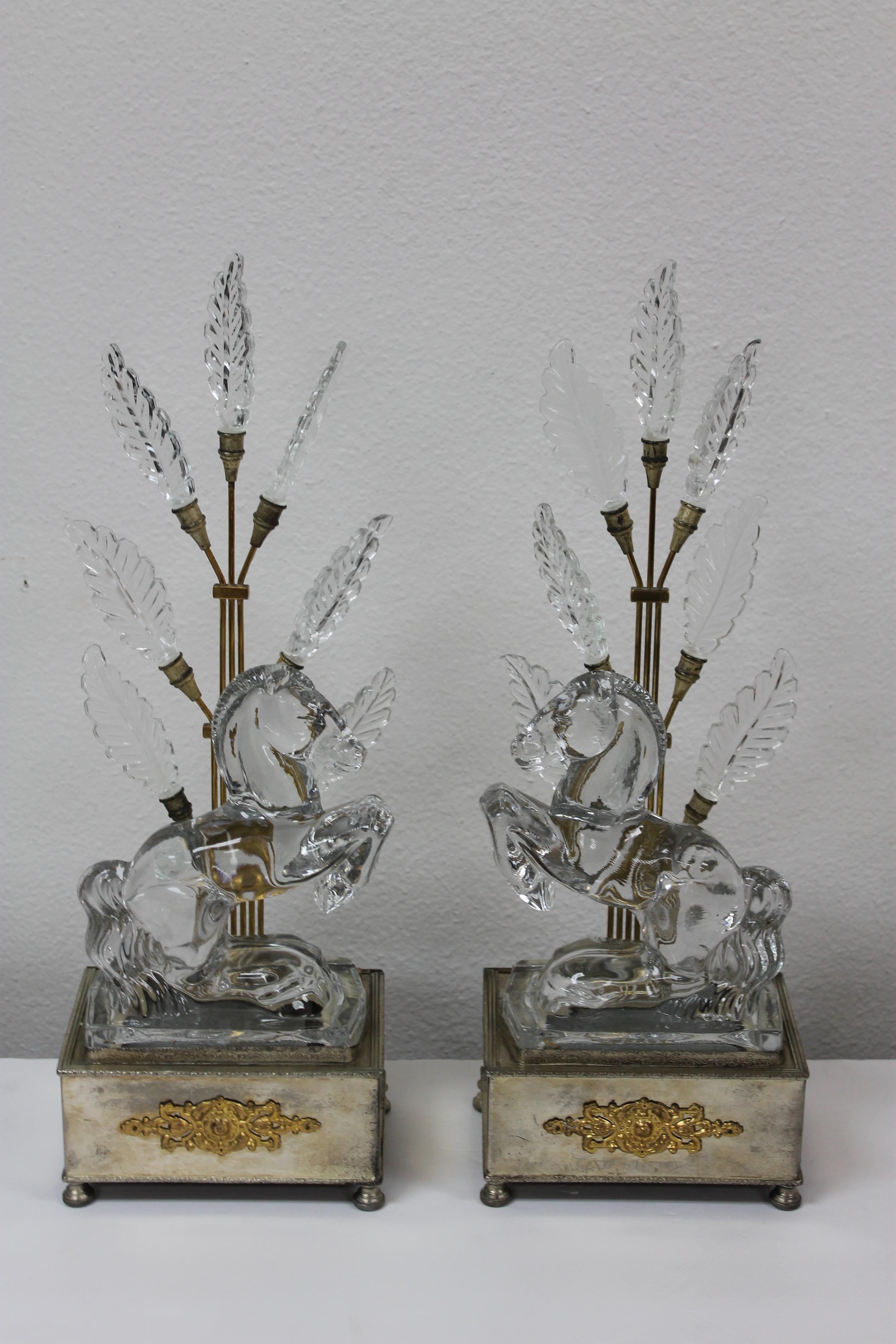A matched pair of early Hollywood Regency accent lamps featuring clear crystal horses in front of stylized bronze trees with crystal leaves. Bases are brass with a silver wash. These are circa late 1930s-early 1940s. Total height is 18