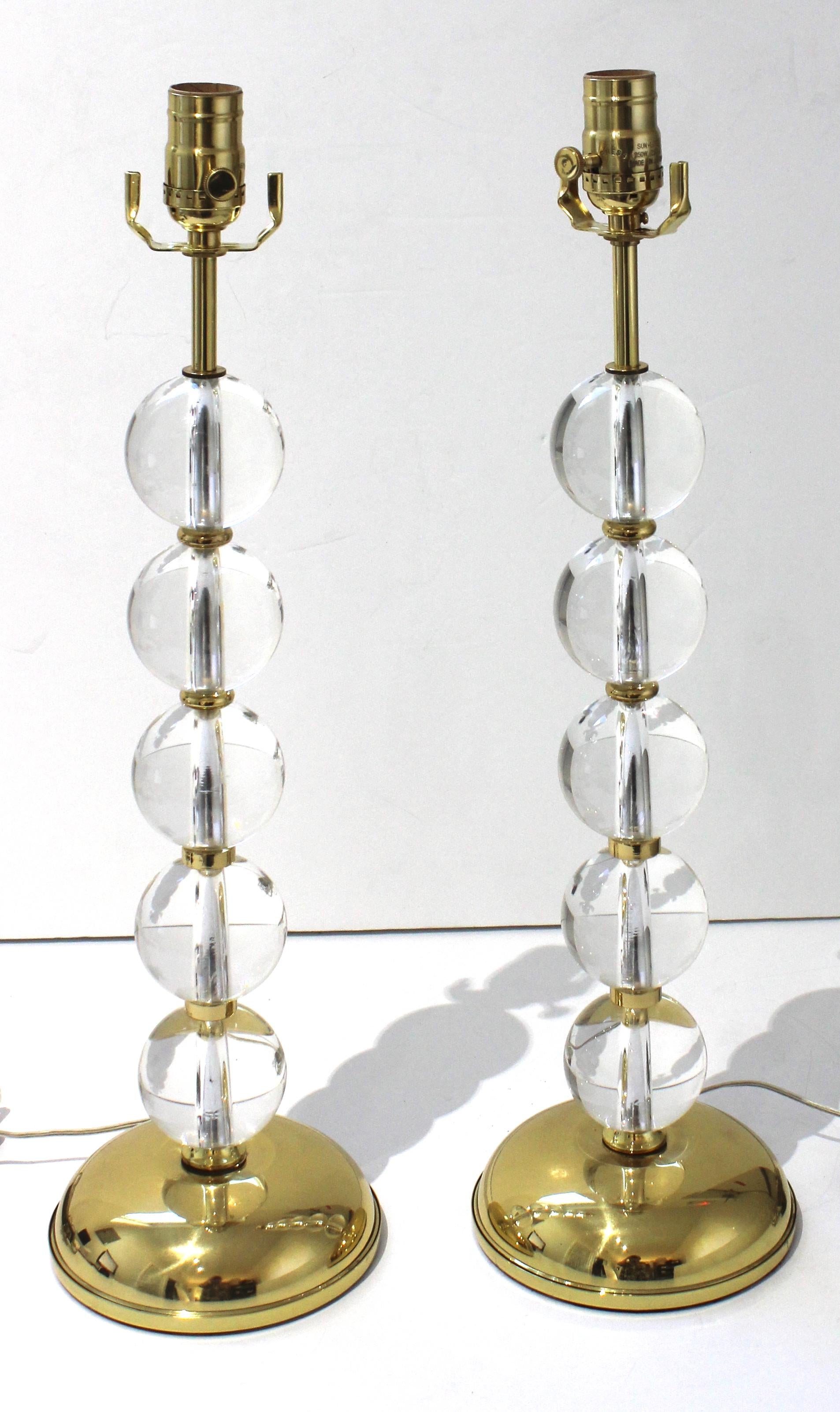 This stylish set of crystal and brass Art Deco table lamps will make a subtle statement with their simple form and use of materials. 

Note: They have a line switch and a socket knob for on and off control.
 