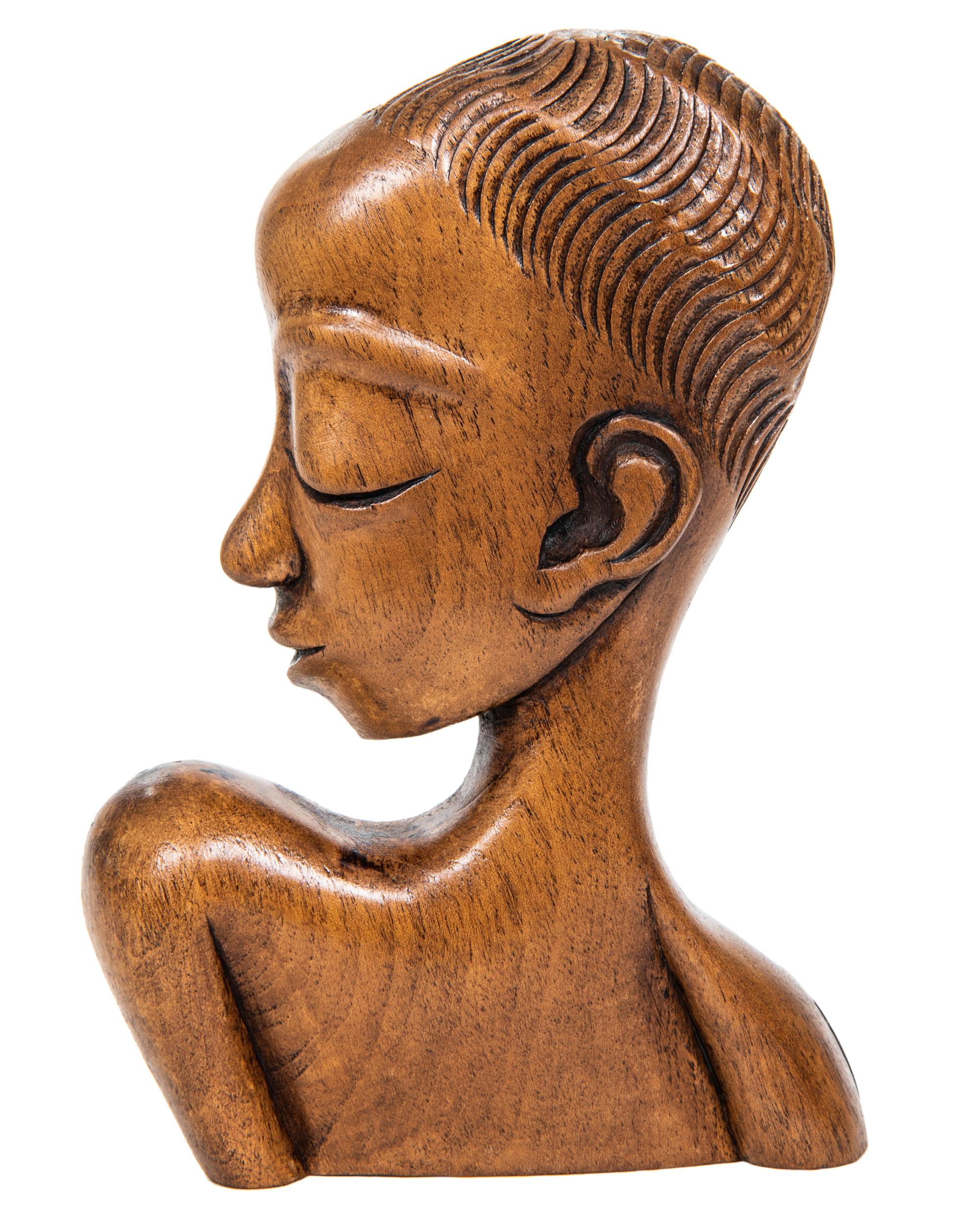This charming pair of stylized midcentury carved wood African figures are in the manner of iconic Austrian designer Karl Hagenhauer.
  