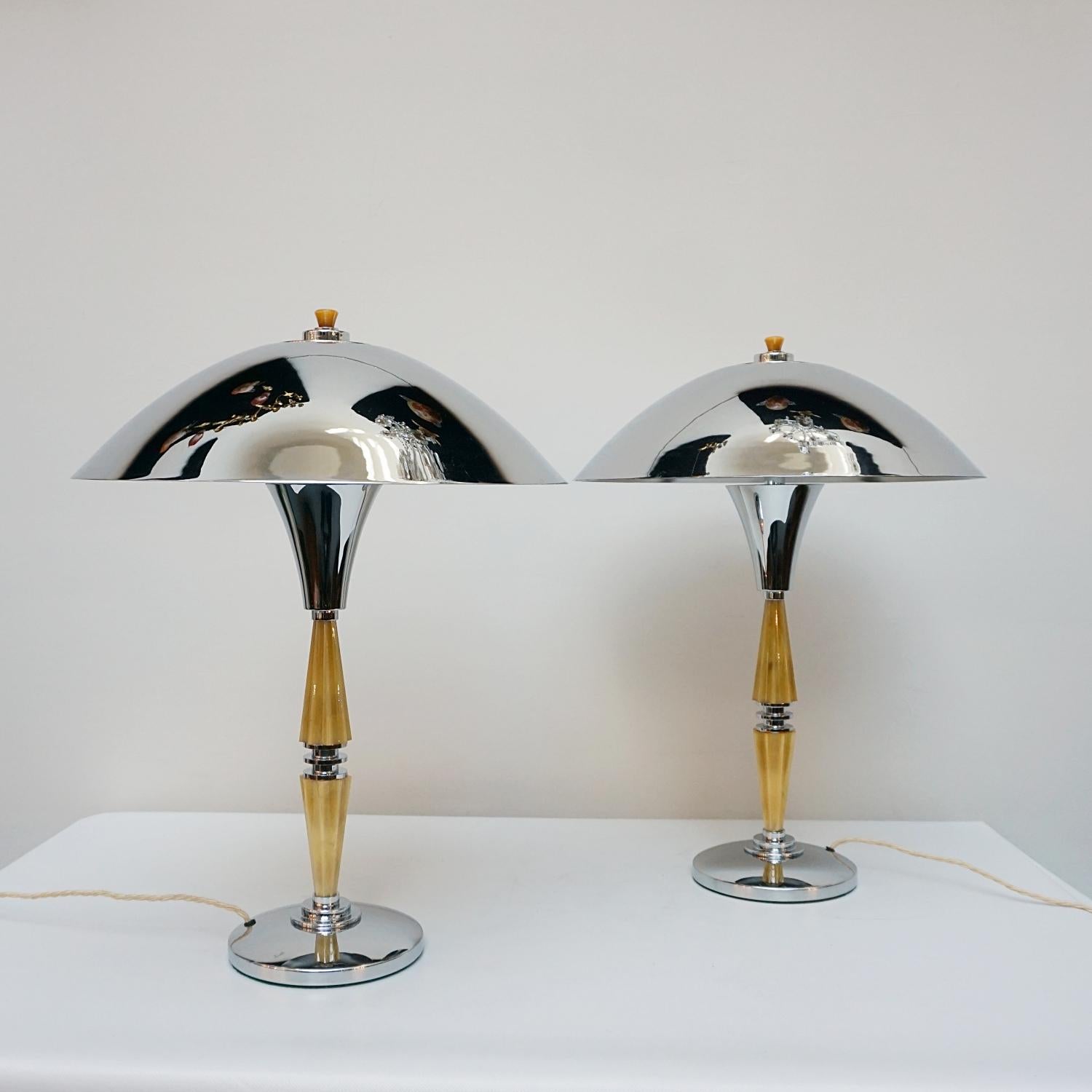 A pair of Art Deco style dome lamps. Yellow fluted bakelite stem with chrome banding, over a chromed metal circular base and a chromed metal shade. Chrome finial to top. 

Dimensions: H 60cm W 19cm

Origin: English

Item Number: J300

All of our