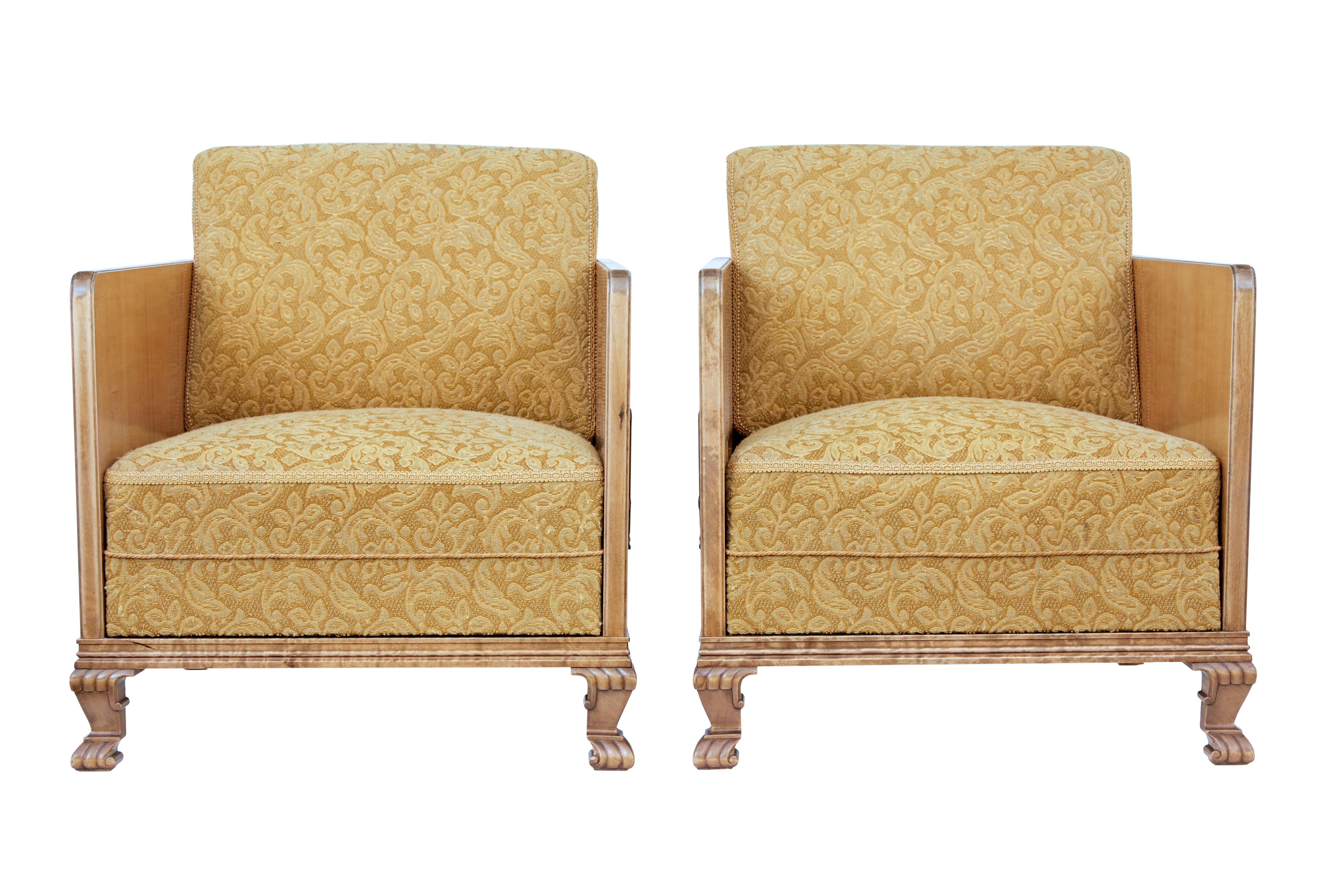 Fine quality pair of Scandinavian elm armchairs, circa 1930.

Thin elm side frame with mahogany stringing and contrasting walnut detail, complete with applied stained birch motif. Standing on front carved paw feet.

Original upholstery is in