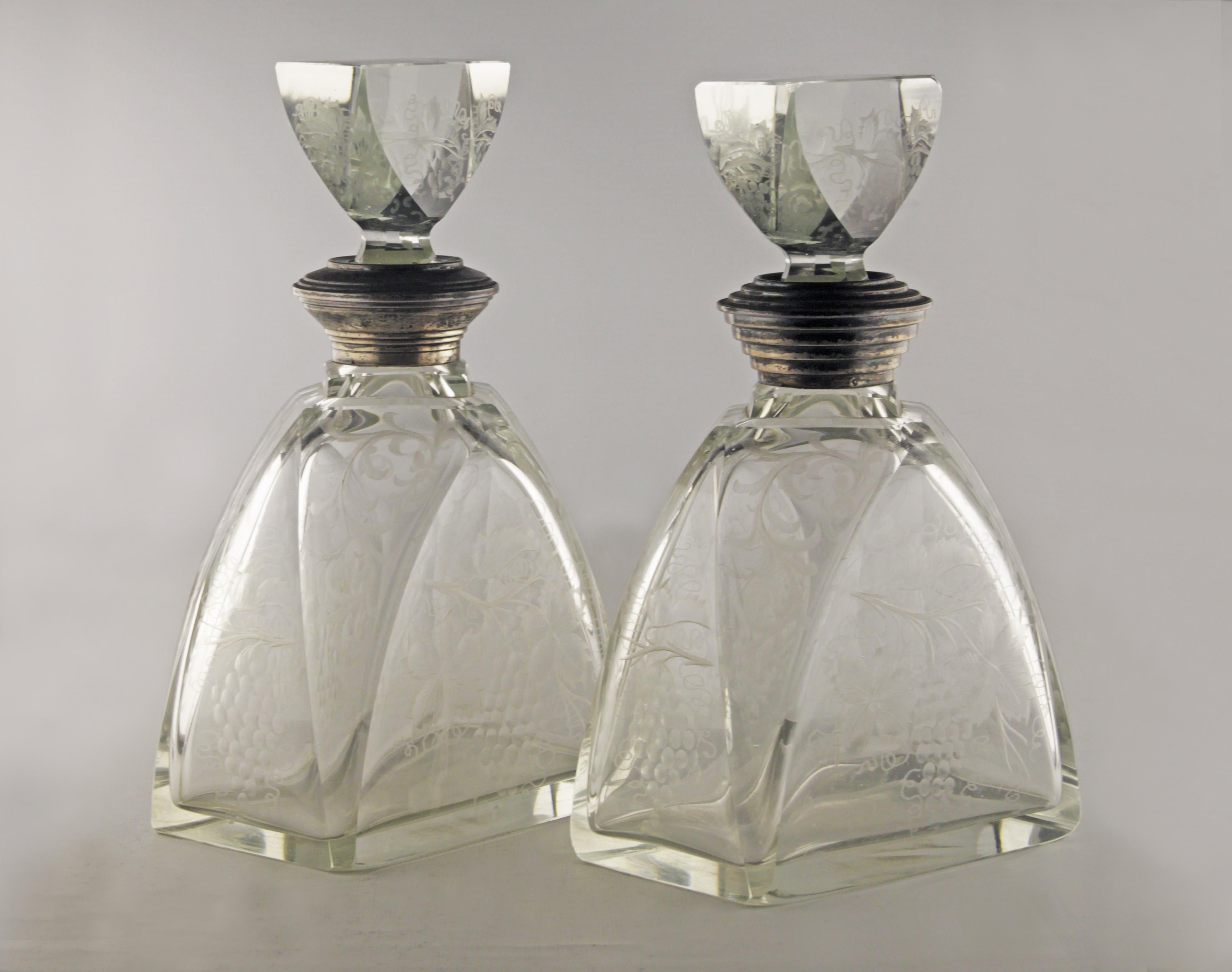 Pair of Art Déco etched glass liquor decanters and stoppers with sterling silver necks

By: unknown
Material: copper, glass, silver, sterling silver, crystal, cut glass, metal
Technique: etched, molded, metalwork, cast, polished
Dimensions: 4 in x 6