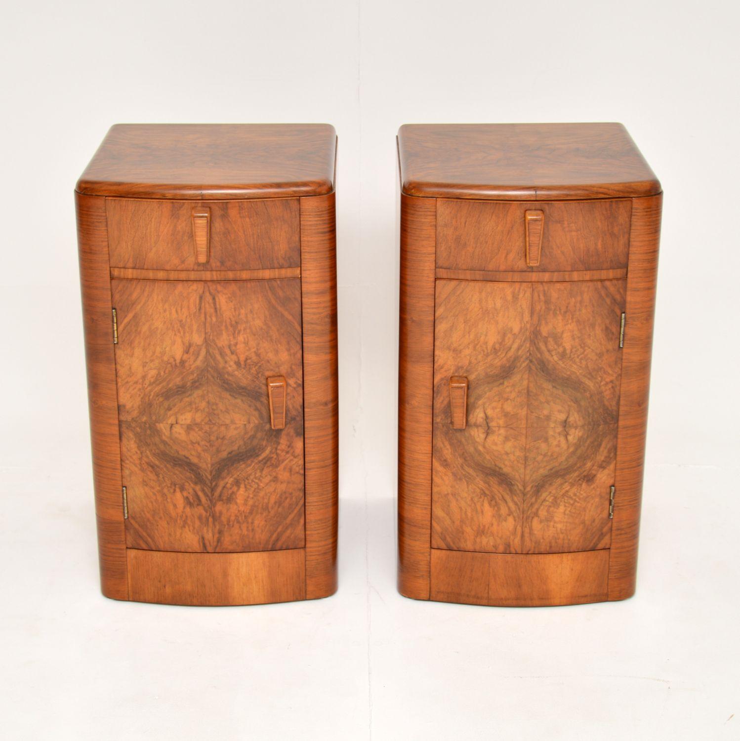 A beautifully made pair of original Art Deco period bedside cabinets. They were made in England, they date from the 1930’s.

Made from richly figured walnut, the colour and grain patterns are stunning. They are a very useful size and offer ample