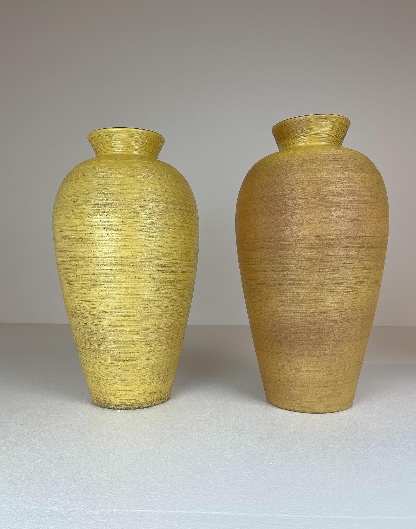 This pair of floor vases were made in Sweden in the 1940s at Ekeby and designed by famous Greta Runeborg.
It is made with grace, that makes the curves and the special glaze to work together.  

Very good condition, small loss on top of the edge