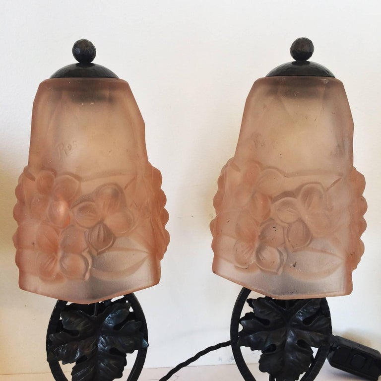 Art Deco pair of lamps, French Art Glass on forged iron with intensely hand-forged base and cap components with a grape vine leaf motif. The pair of art glass shades are Pate de verre, and both are signed “Ros” in raised script. The lamps have been