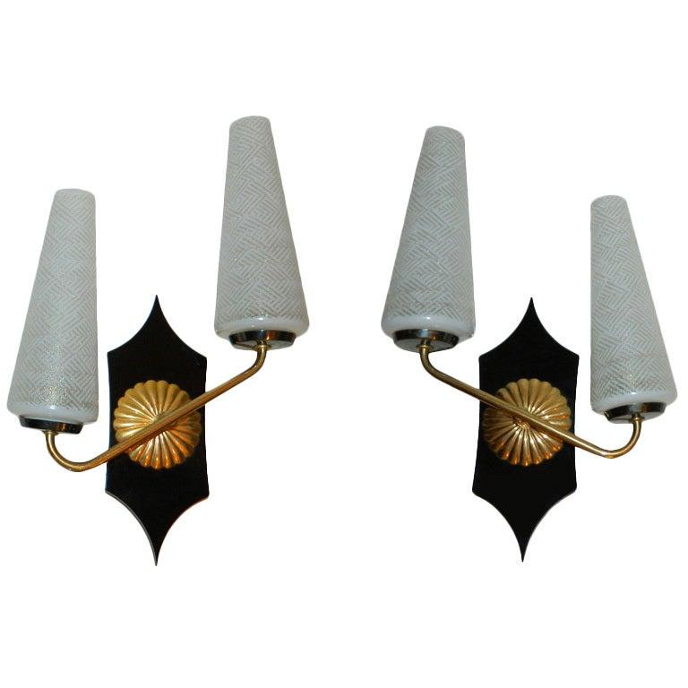 Art Deco pair of sconces, wall lights in brass and Bakelite with the original blown cone Opaline glass shades.
US rewiring and in working condition, each Sconce takes 2 Light bulbs with max. 40 watts.
Have a look on our the largest collection of