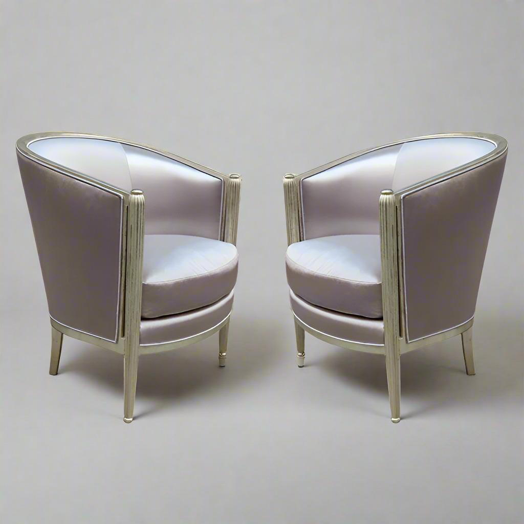 A fine pair of Art Deco white gold armchairs. 
White gold leaf with fluted front leg details.