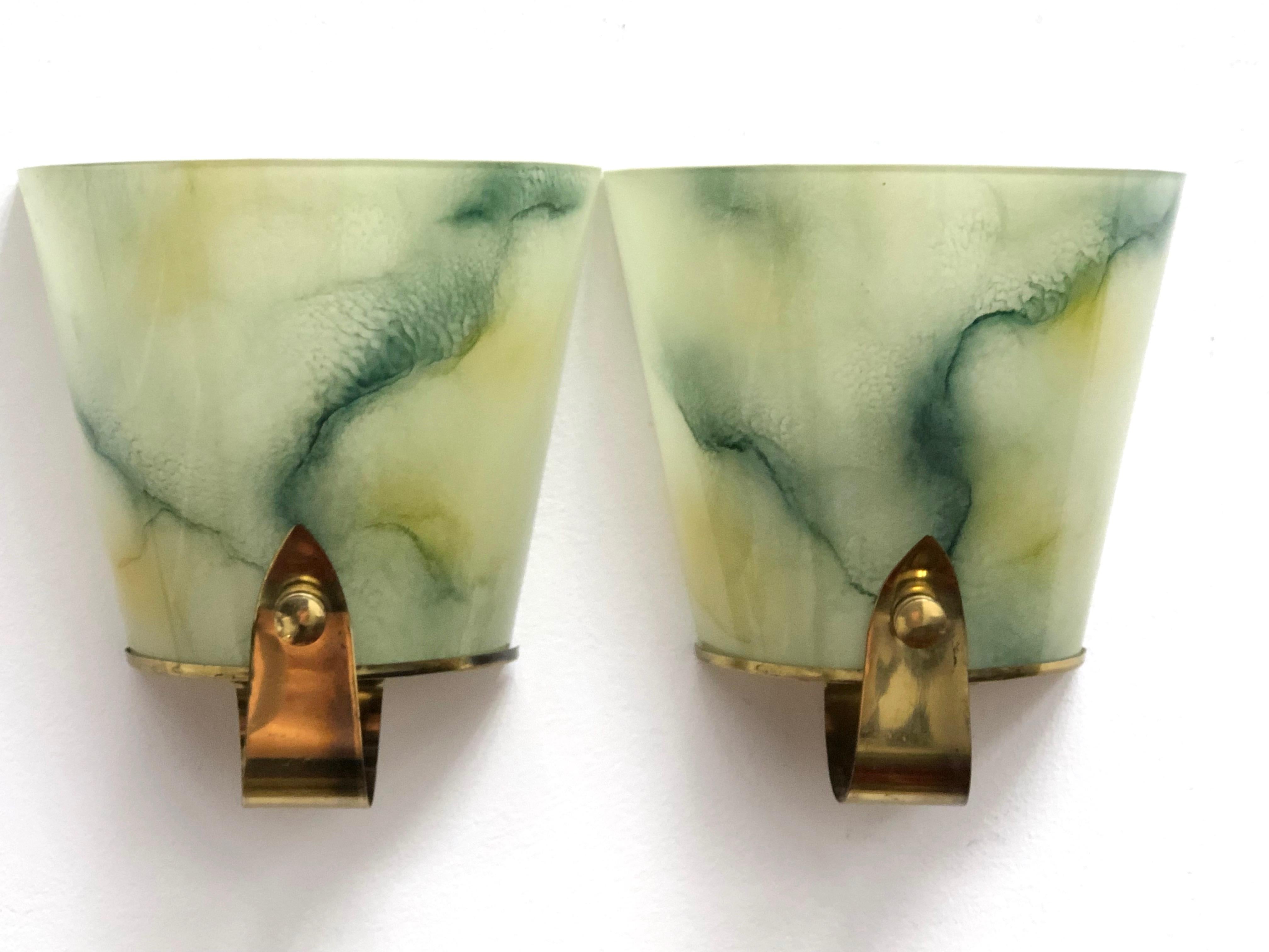 Pair of Art Deco sconces. Beautiful marble style glass on a brass frame. The fixture requires one European E27 / 110 Volt Edison bulbs, each bulb up to 75 watts.