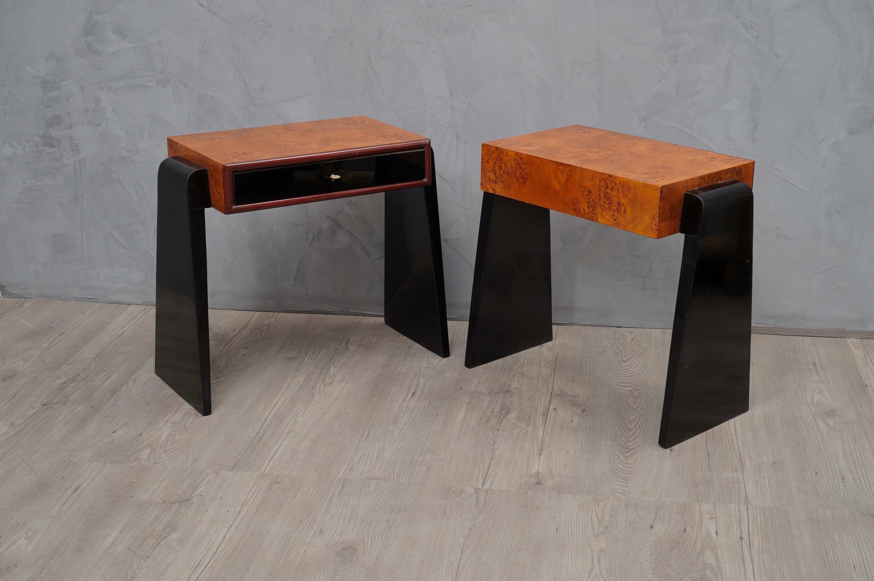 Pair of beautiful tables with a very particular design, a very luxurious appearance due the use of not common materials.

The body and top of the table is veneered in poplar briar wood, while a black glass opal has been applied to the drawer at