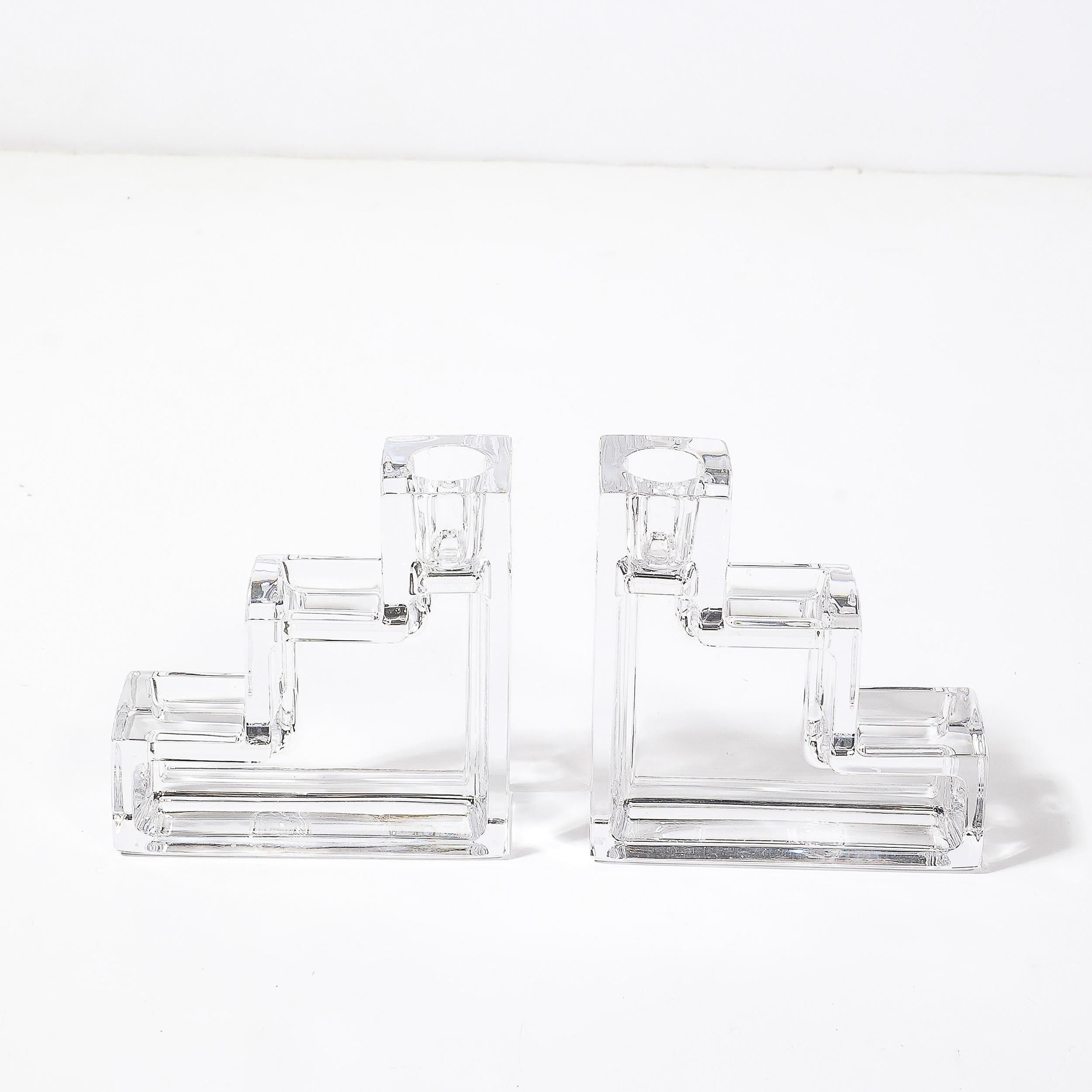 This distinguished pair of Art Deco glass candlestick holders, designed by Wilber Orme for the Metropolitan Museum of Art, epitomizes the glamour and precision of American Art Deco craftsmanship, circa 1930. Characterized by their bold step-form