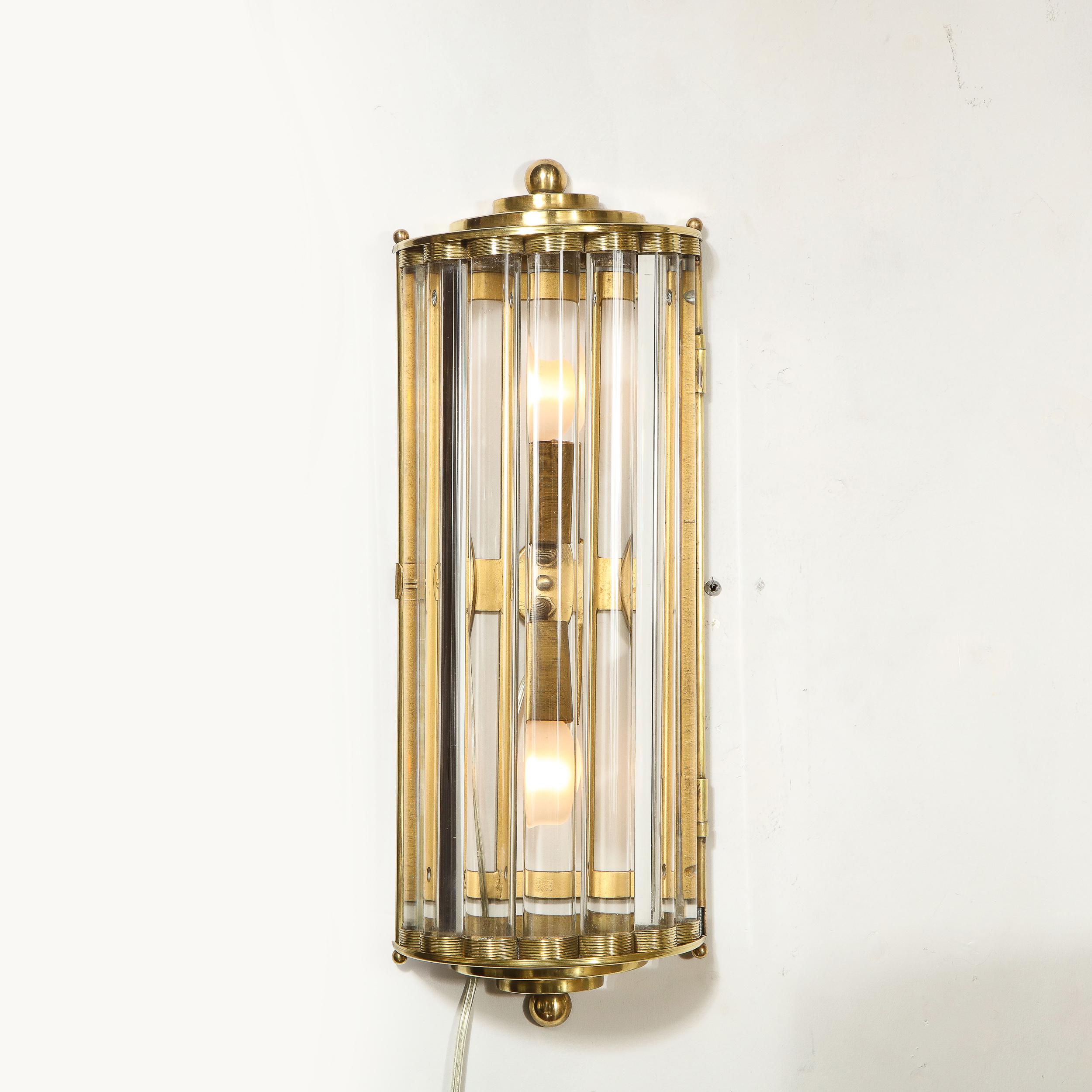 This of Art Deco Handblown Murano Glass Rod and Brass Sconces were produced and signed by the fabled atelier of Venini in Italy, circa 1930. Each sconce offers seven translucent glass rods that are secured by channeled and streamlined brass