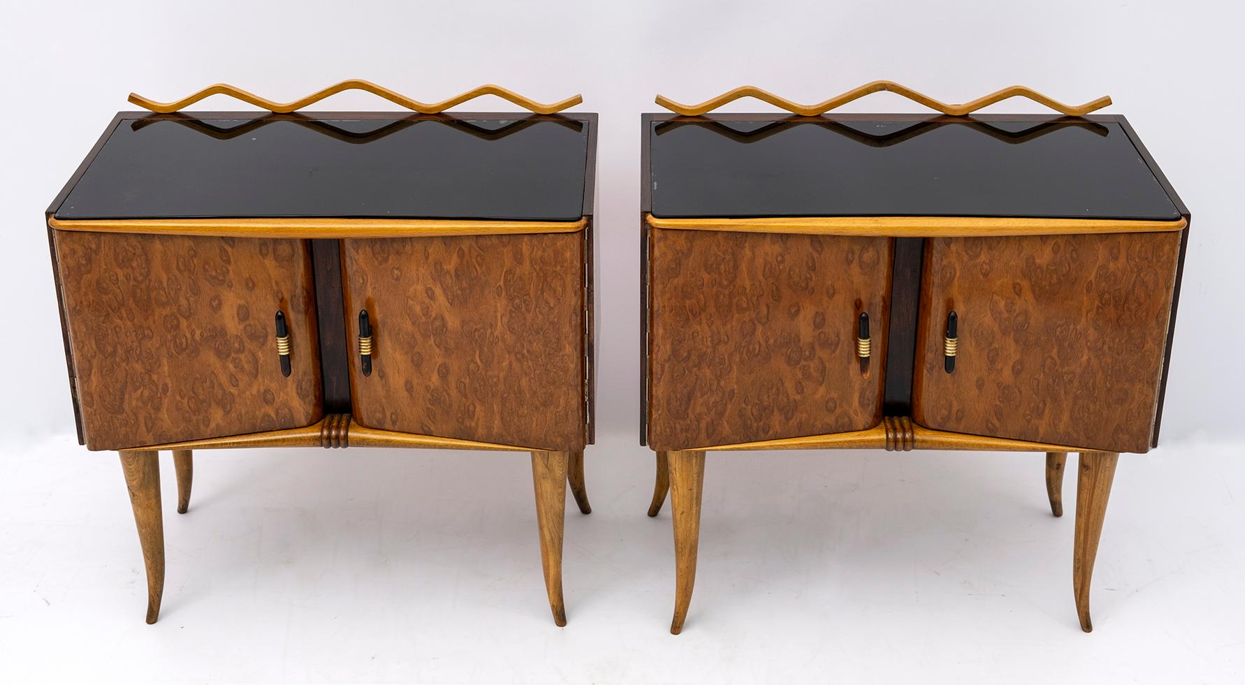 This pair of bedside tables was produced in Italy in the 1920s, Art Deco period. They were made of maple wood, ash burl and walnut, the top is in black painted glass, the structure is in poplar, the handles in brass and bakelite. They have been