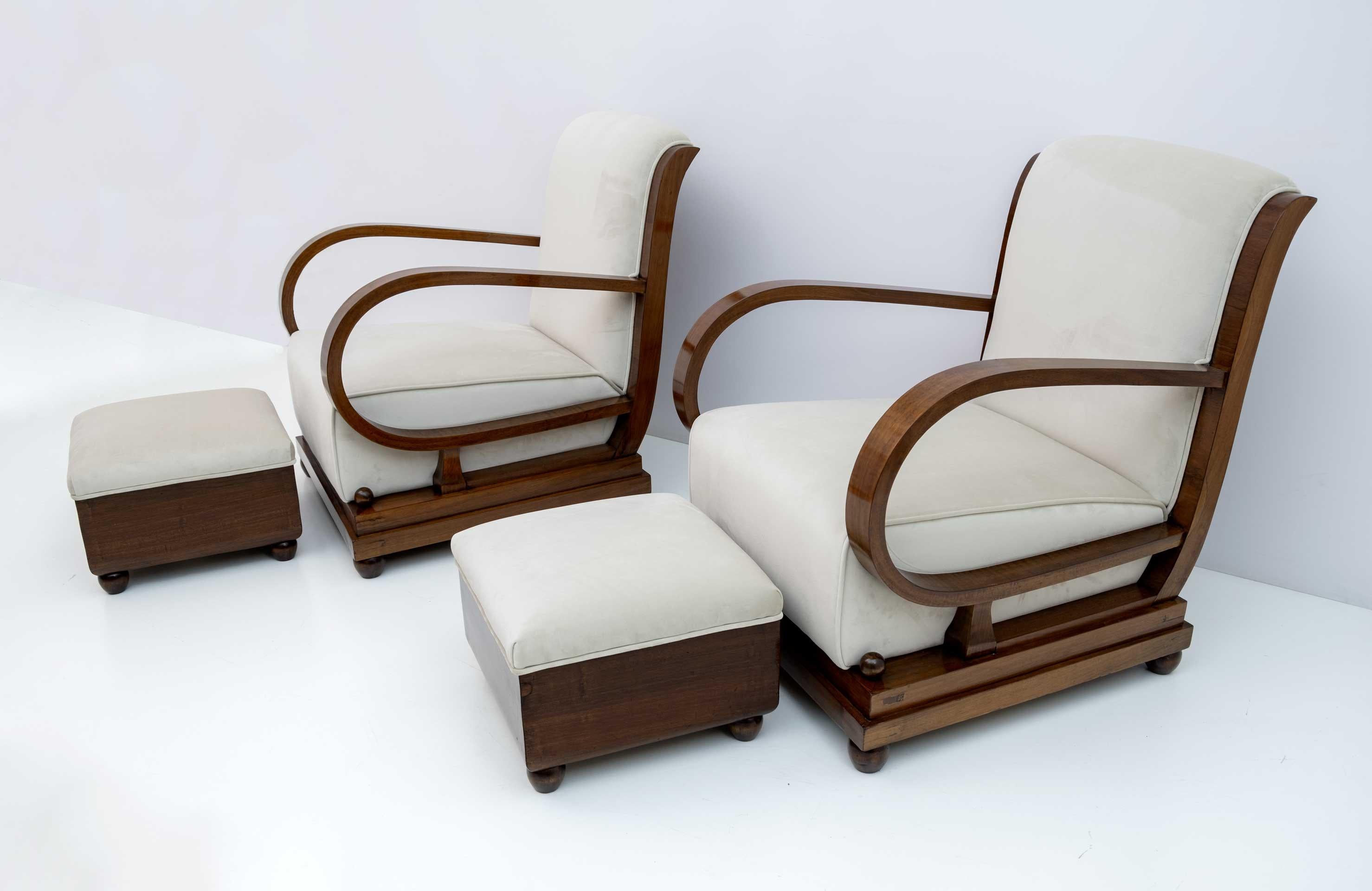 Italian set from the 1920s composed of a pair of armchairs and two poufs. From the early Art Deco period of Northern Italy, upholstered in walnut and ivory velvet, the backs of the sofa and armchairs are gracefully curved and extend out to
