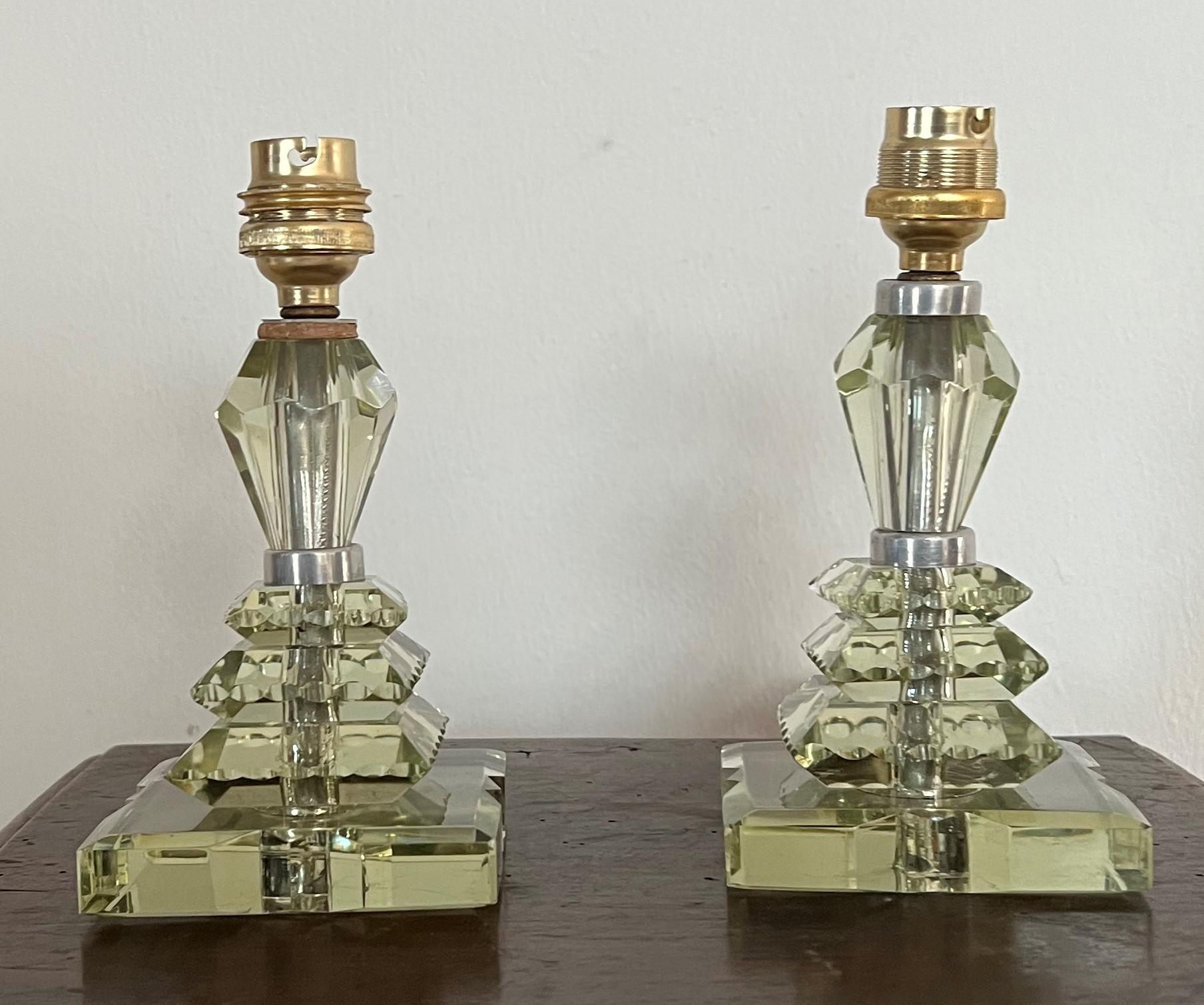 Beautiful pair of table lamps in ther style of Baccarat and Jacques Adnet but they are not marked.
Manufactured in hand cut slightly green Lead glass.
France circa 1940.
The pieces 