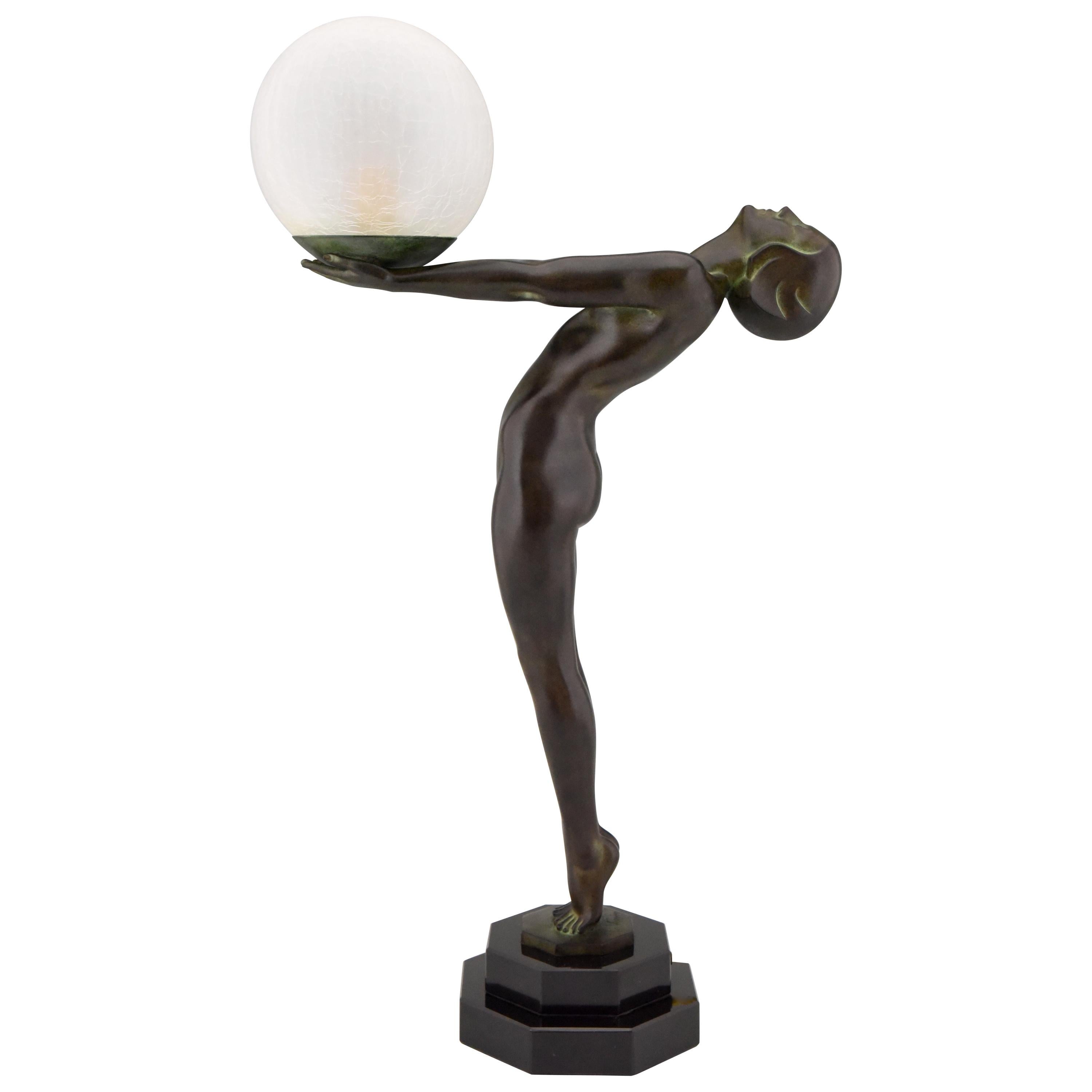 Impressive pair of Art Deco figural table lamps of a standing nude holding a glass shade, Lumina.
H. 65 cm or 25.6 inch tall.
Designed by Max Le Verrier in France, 1928.
Original posthumous contemporary cast at the Le Verrier foundry. 
Handcrafted.
