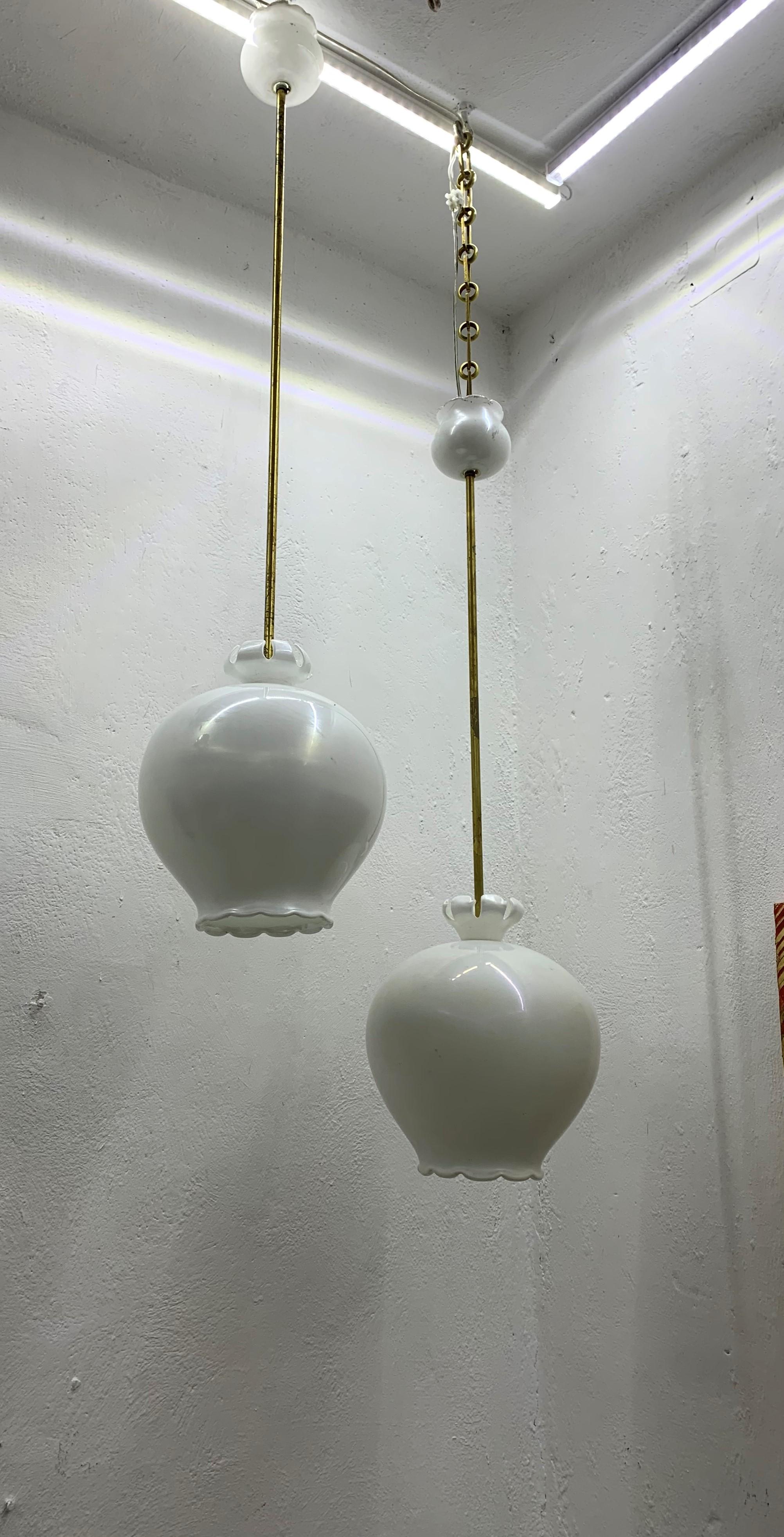 Beautiful Mid-Century Modern 1-light chandeliers in hand blown pearl white glass and brass, the design is attributed to Flavio Poli and the manufacture to Seguso vetro di Arte, circa 1940s.
Priced individually. 
These previously hung in a hallway in