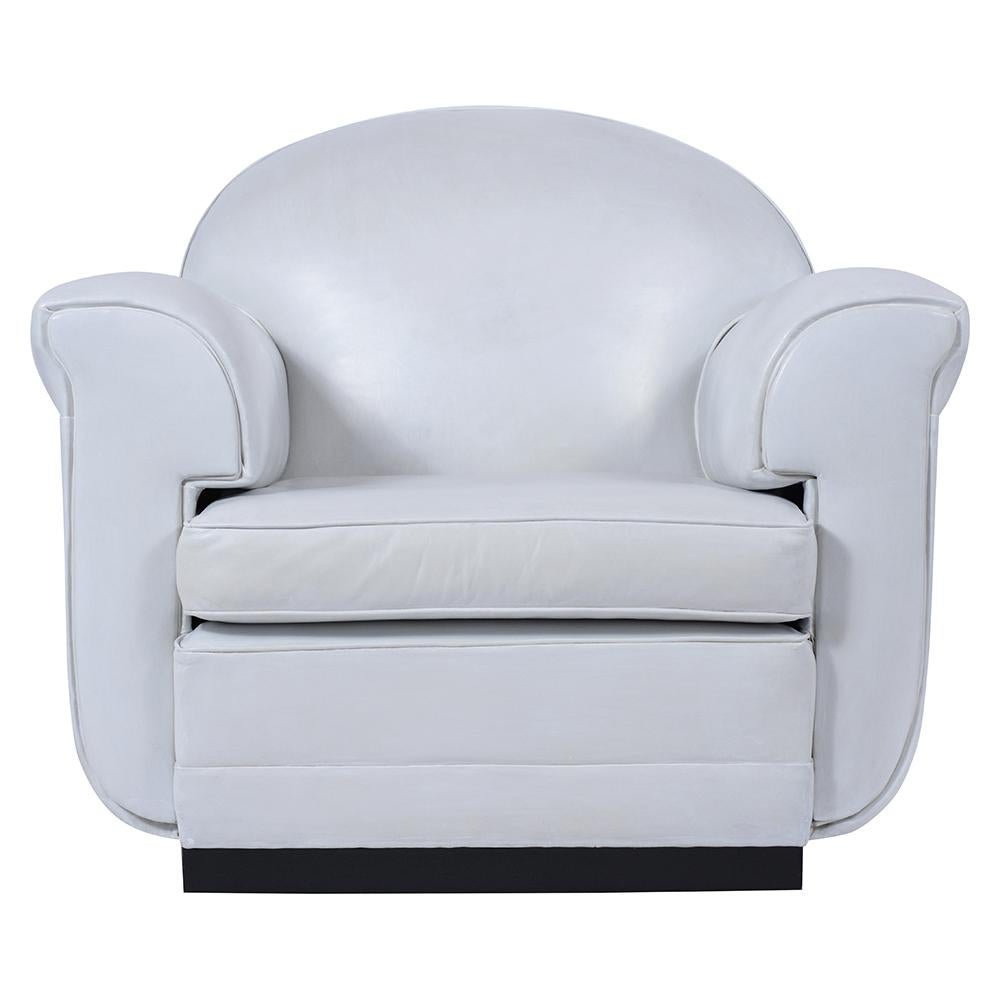 An extraordinary pair of art deco-style leather club chairs covered in white leather upholstery is in good condition and has been restored by our team of craftsmen. These sleek 1960s modern design chairs feature a removable cushion, thickly padded
