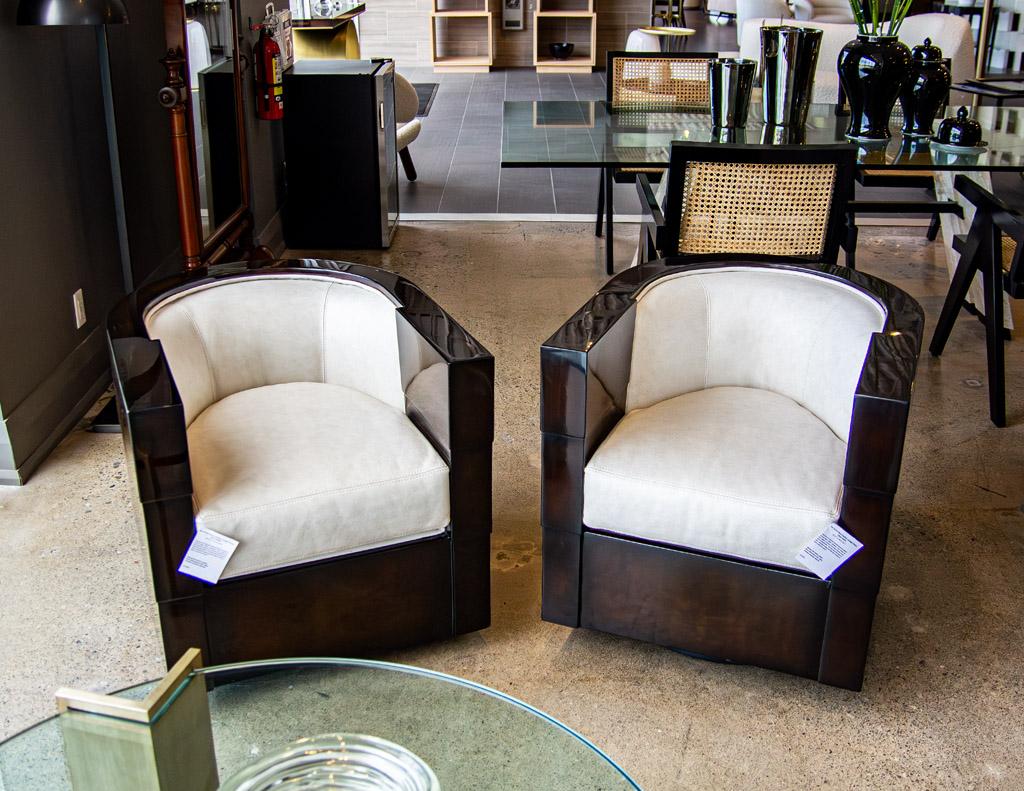 This stunning pair of art deco leather lounge chairs, circa 1940's, are a must-have for any living space. Featuring a rich high gloss espresso finish and beautiful textured Italian leather upholstery. Their unique art deco styling is composed of