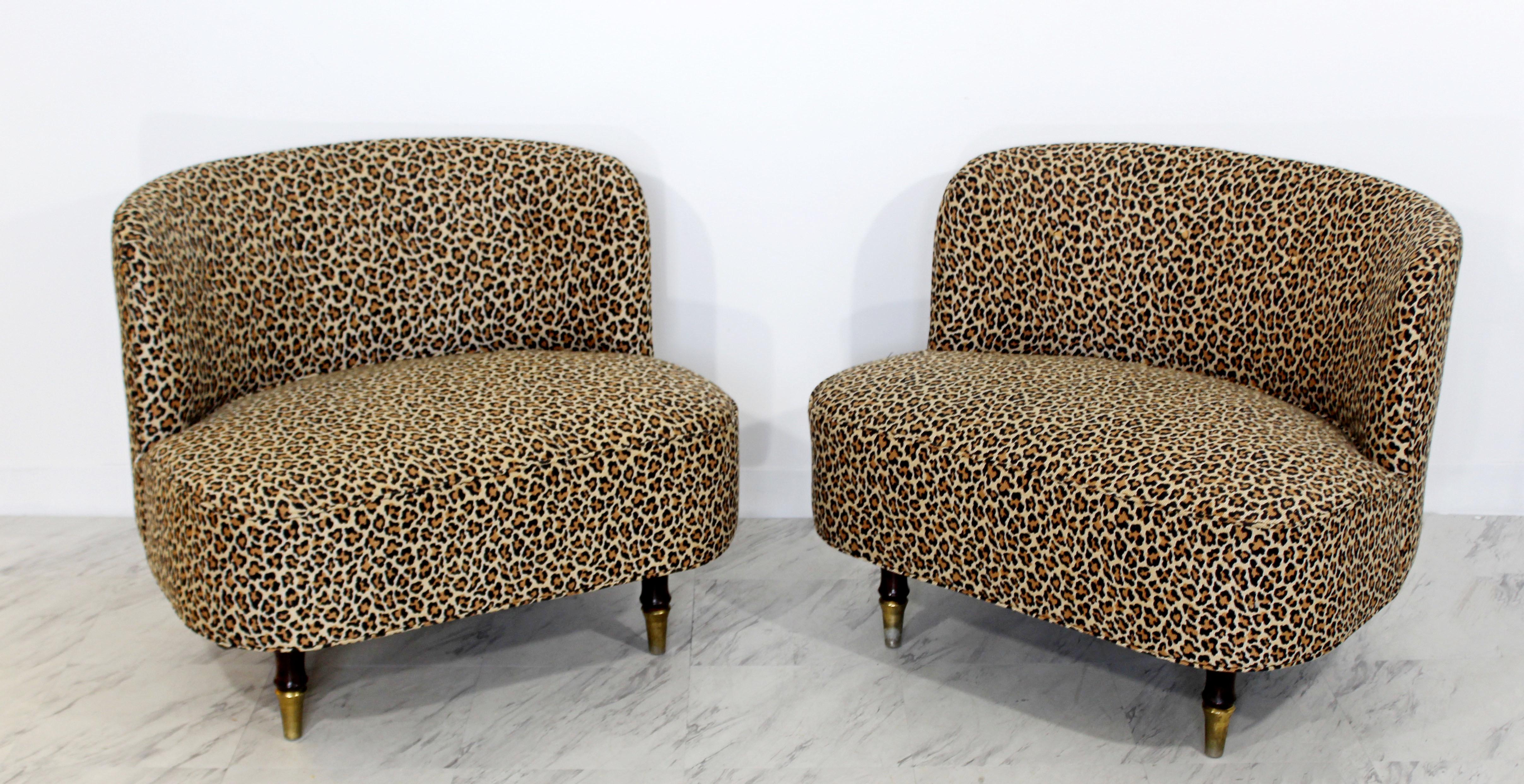 For your consideration is an incredible pair of tufted slipper chairs, with a leopard print upholstery on brass and mahogany legs, in the style of Gilbert Rohde or Billy Haines. In excellent condition. The dimensions are 32