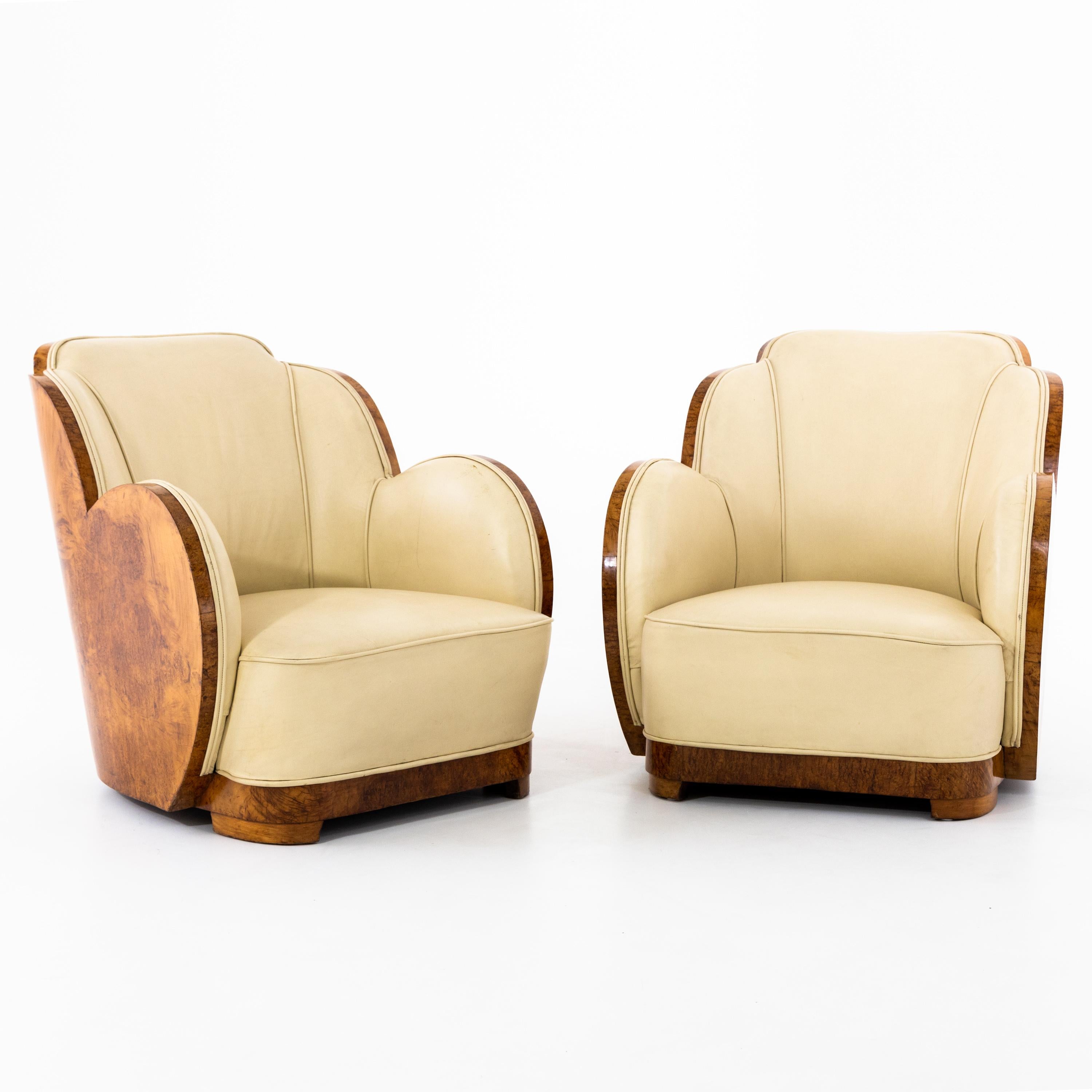 Pair of Art Deco cloud chairs with beautiful scalloped seats, covered in beige leather.