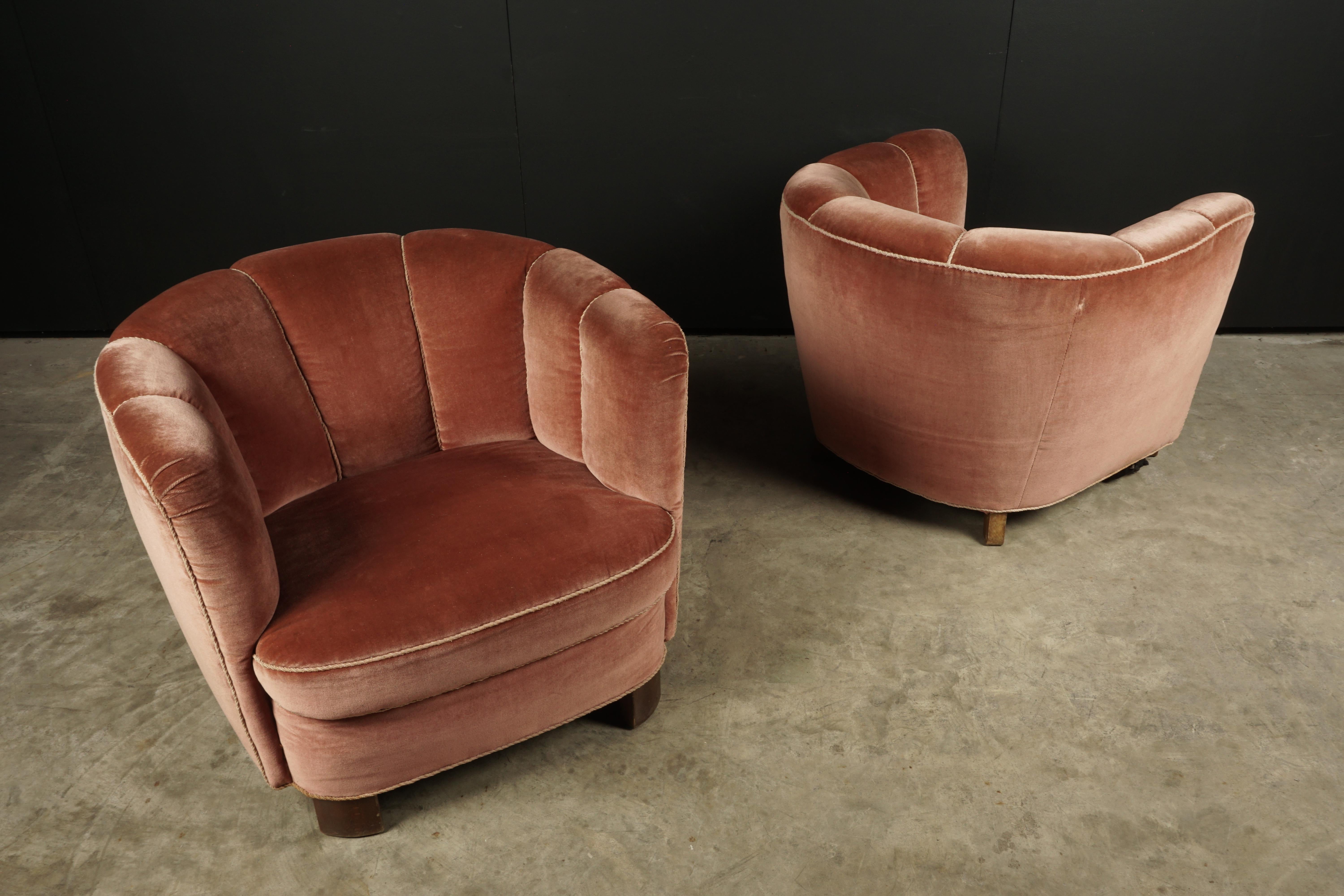 Vintage pair of Art Deco lounge chairs from Denmark, circa 1950. Large, comfortable model with rose colored velvet upholstery.