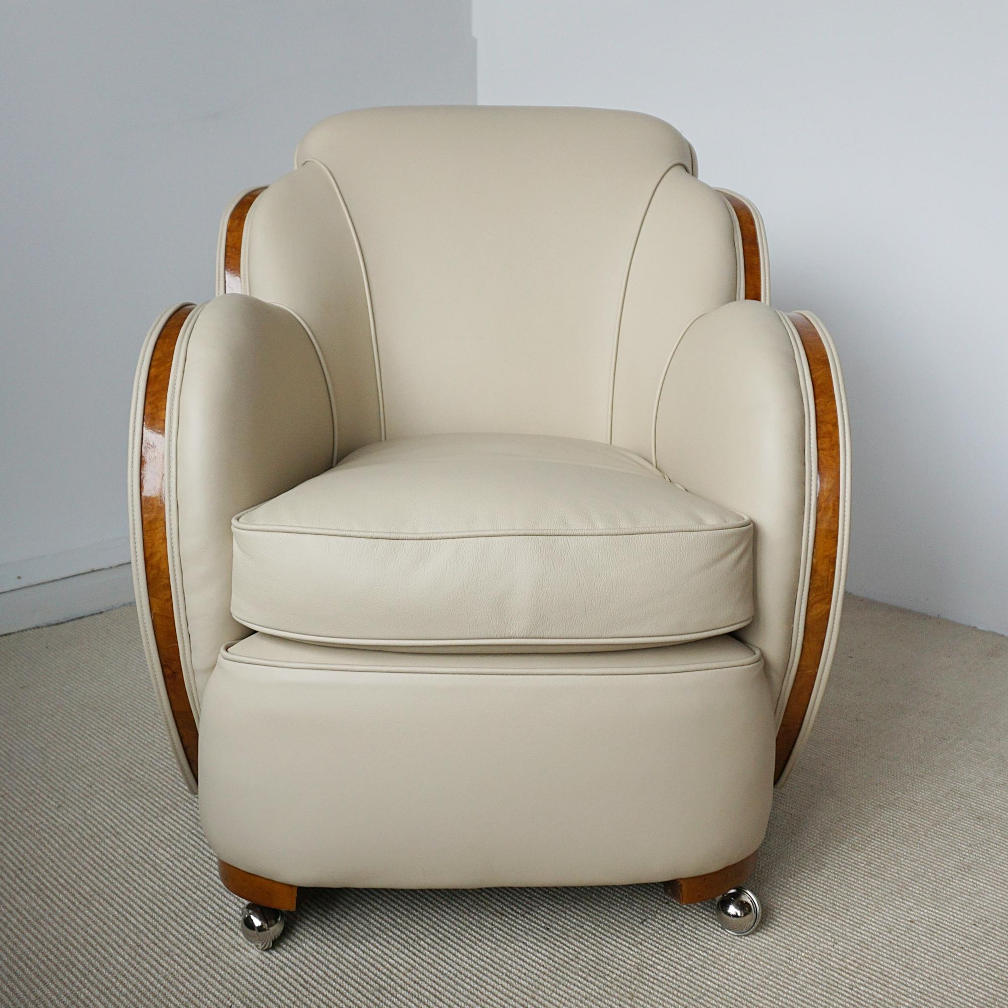 A Pair of Art Deco 'Cloud' lounge chairs by Harry & Lou Epstein. Burr walnut banding with cream leather re-upholstery and contrasting faux suede to sides and back. Replacement chrome castors. 

Dimensions: H 85cm W 72cm D 75cm Seat H 46cm W 43cm D