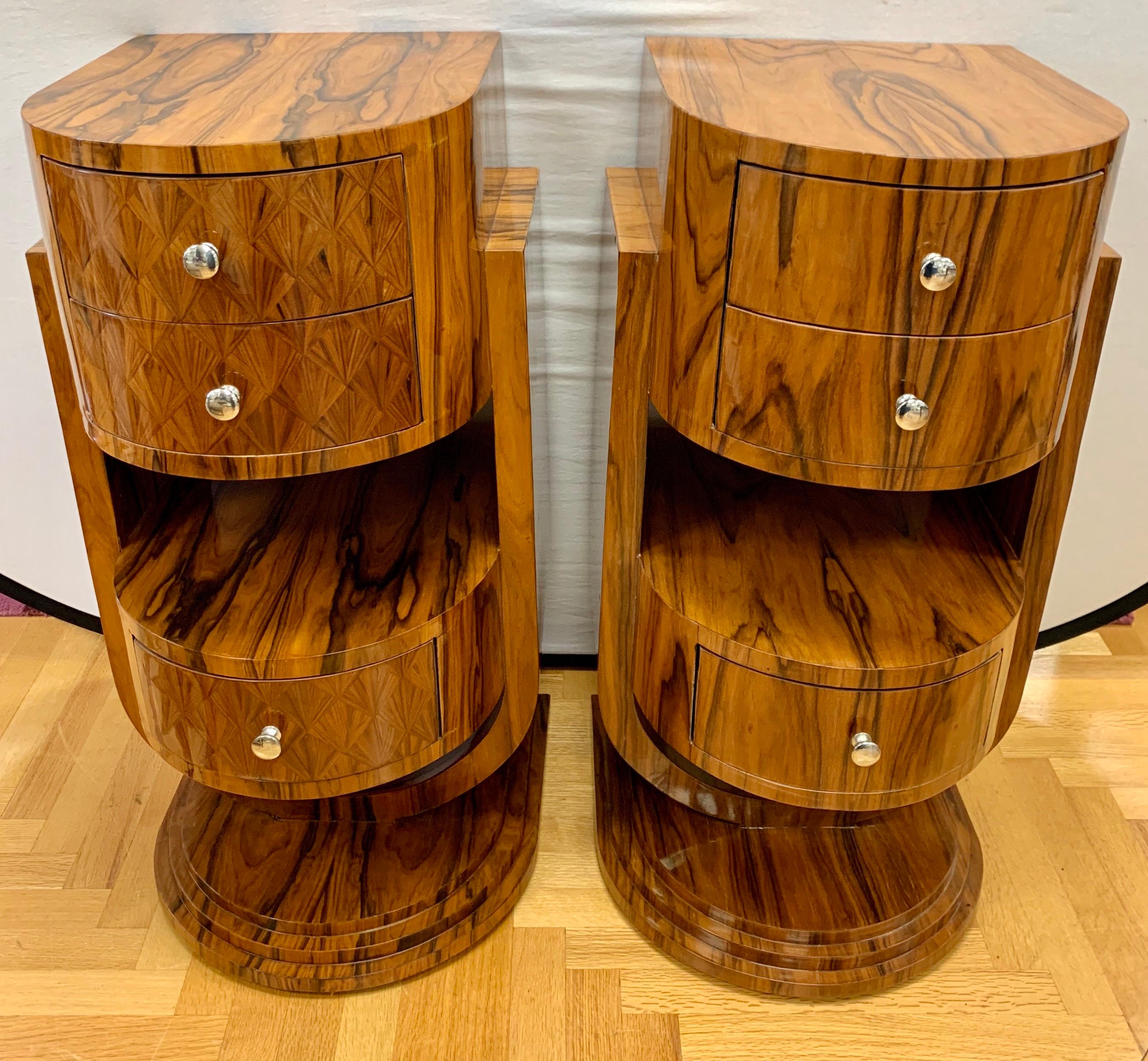 Wonderful pair of curved Art Deco nightstands with bookmatched Macassar wood veneer with three drawers and one shelf for storage. Use them as a set of end tables or as nightstands. Note that they are not identical as the patterns on the drawers