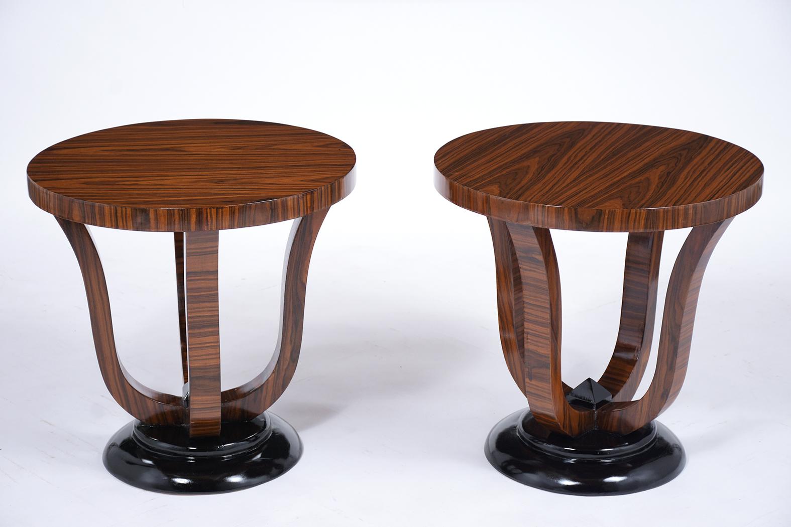 This pair of French art deco macassar side tables are in great condition have ebonized details and a newly lacquered finish. These end tables are covered in their original macassar veneer, circular round top, and rests on a sturdy pedestal base with