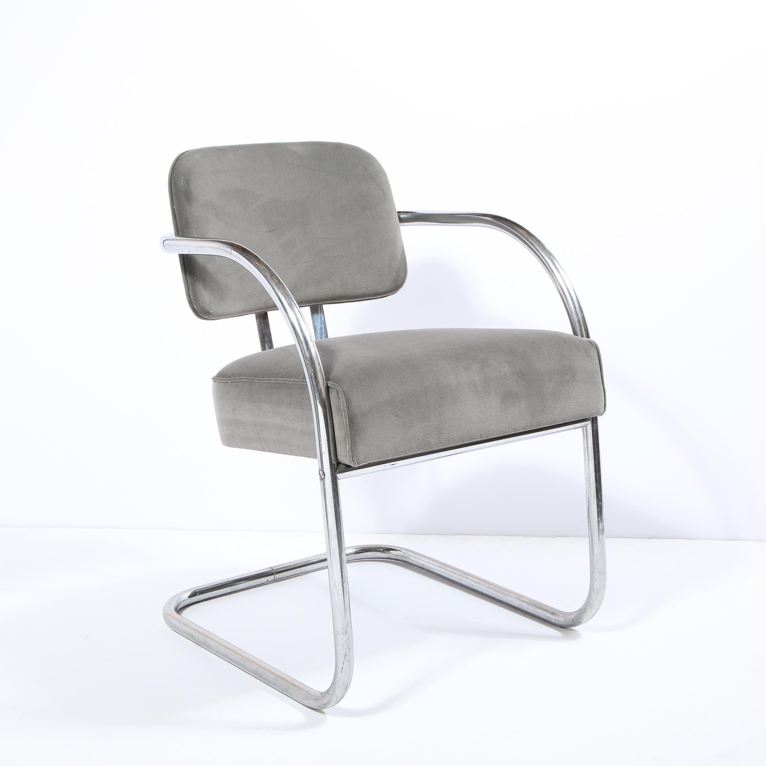 This sophisticated Art Deco Machine Age occasional/ side chair was realized in the United States, circa 1935. It features a subtly cantilevered tubular bent aluminum frame with a floating back seat, streamlined arms, and a gently rounded cushion