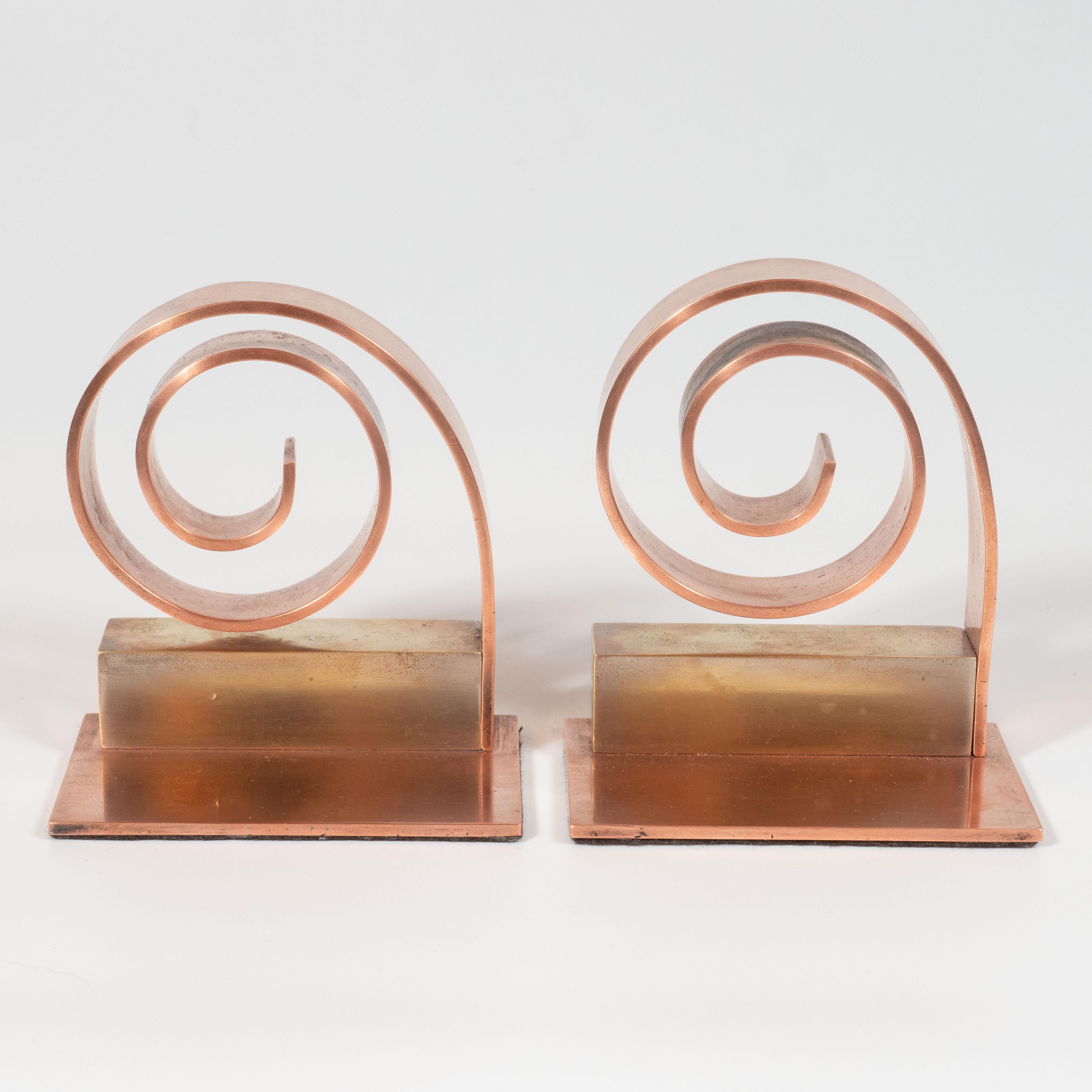 This elegant pair of Art Deco machine age scroll form bookends were designed by the celebrated luminary Walter Von Nessen and realized in the United States, circa 1950. With their clean lines and dynamic form, these bookends would be a winning
