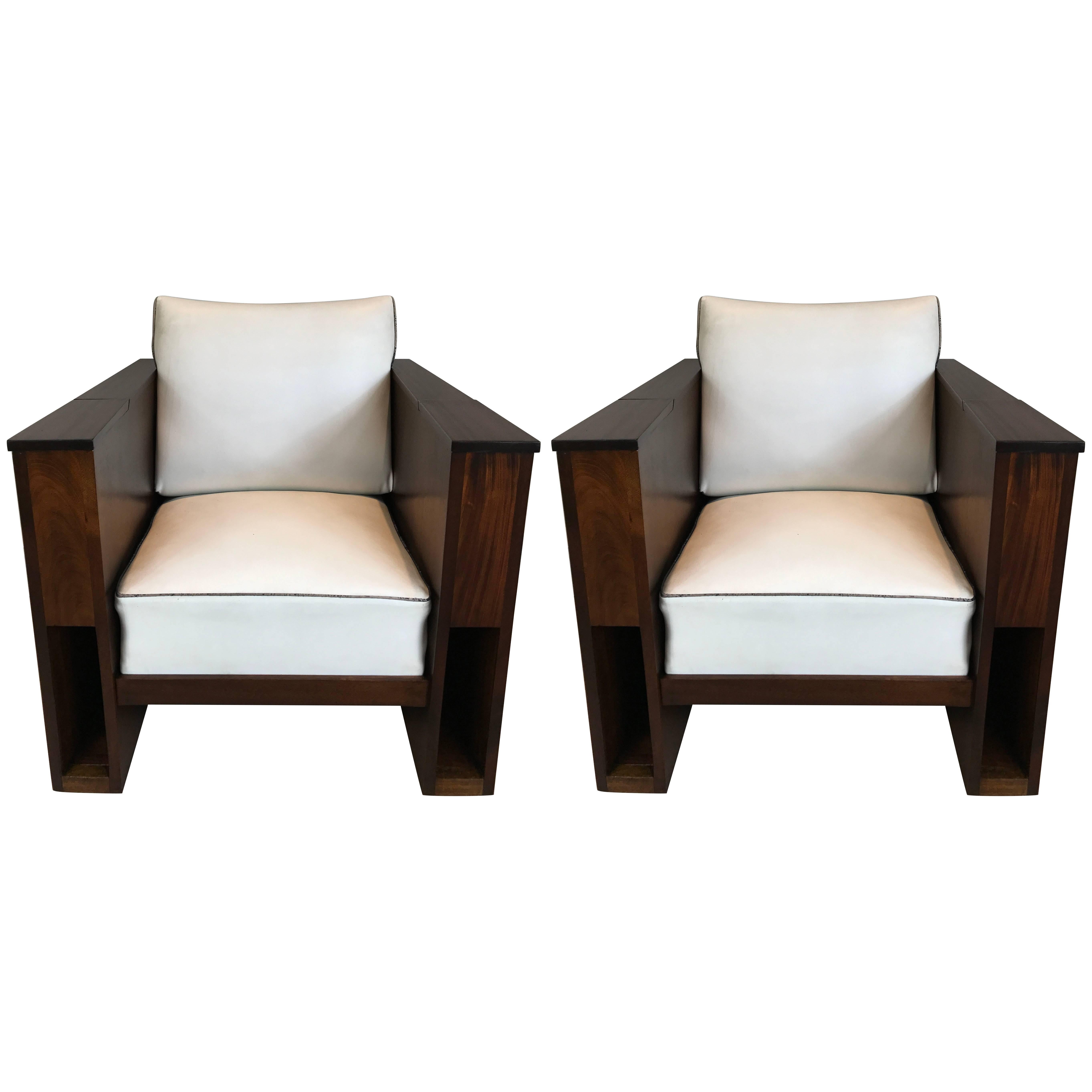 Stunning and rare pair of Art Deco mahogany case club chairs. A great example with architectural front alcoves and flip-top compartments on each arm. Original upholstery but we provide upholstery service in customers own material depending on