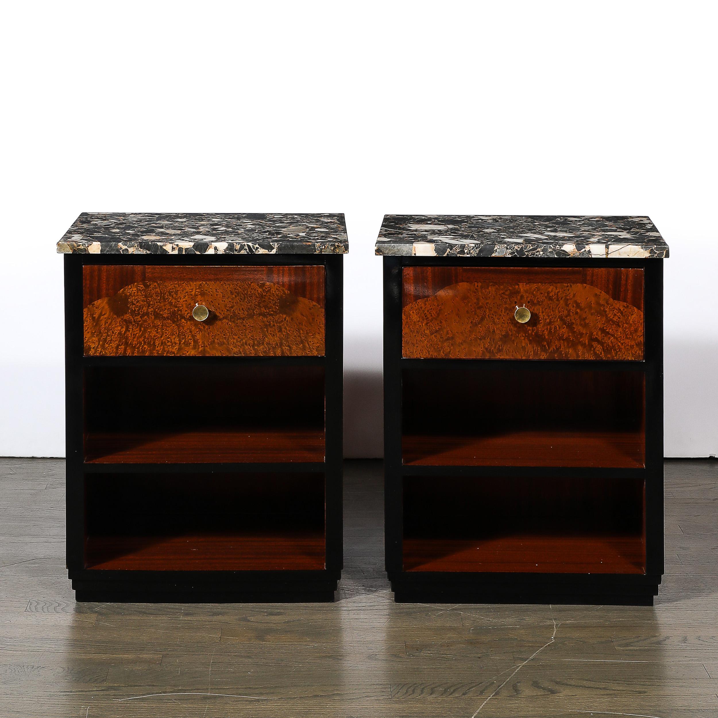 This materially stunning and well formed Pair of Art Deco Marble Top Nightstands in Bookmatched Walnut & Burled Carpathian Elm Inlays W/ Black Lacquer Detailing originate from France, Circa 1935. Featuring a subtle rectilinear profile with