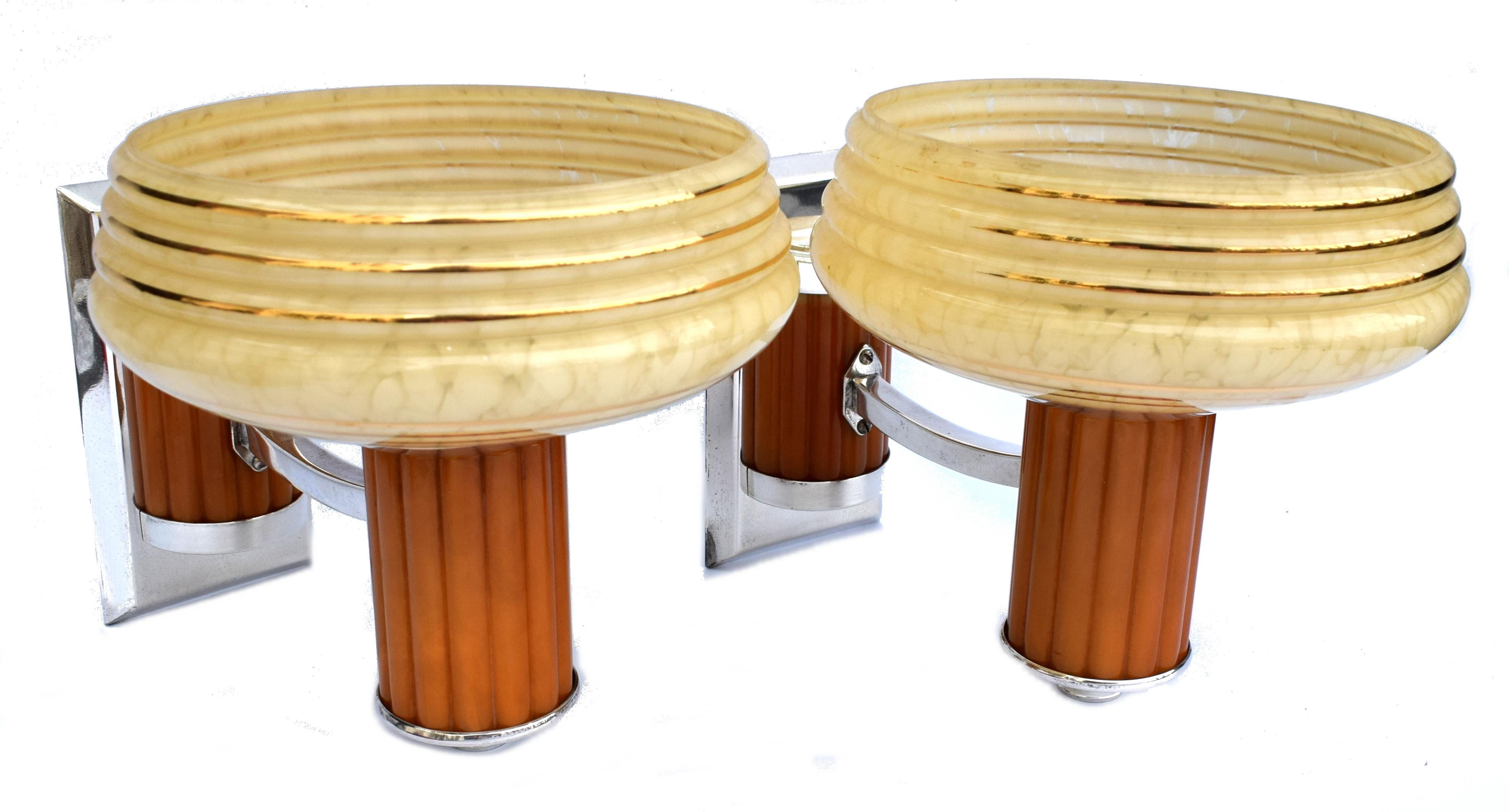 A very rare chance to acquire a pair of matching Art Deco wall light sconces. Made from butterscotch colored catalin/phenolic Bakelite and copper metal-ware with mottled glass yellow colored shades. These lights make a great statement to any room
