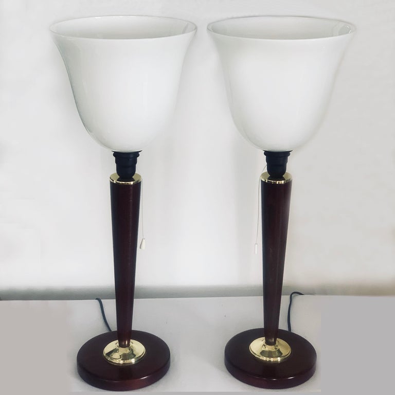 Midcentury pair of French Mazda lamps with all original fittings including pull cord switch to upper support for opaline glass shade. The cord and white Bakelite tab is pristine and has possibly been replaced in recent decade. The polished mahogany,